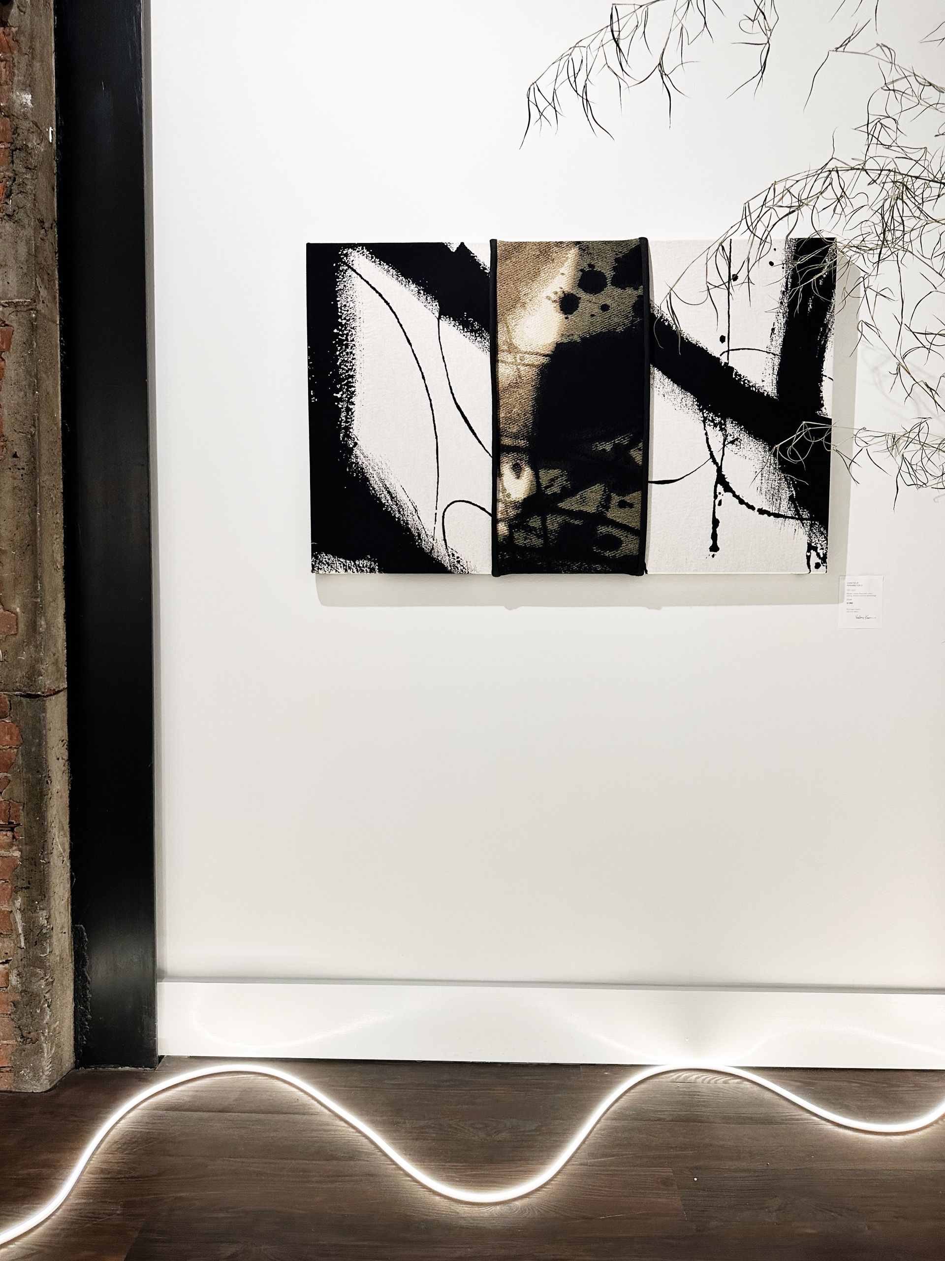 A painting on a wall with the letter n on it