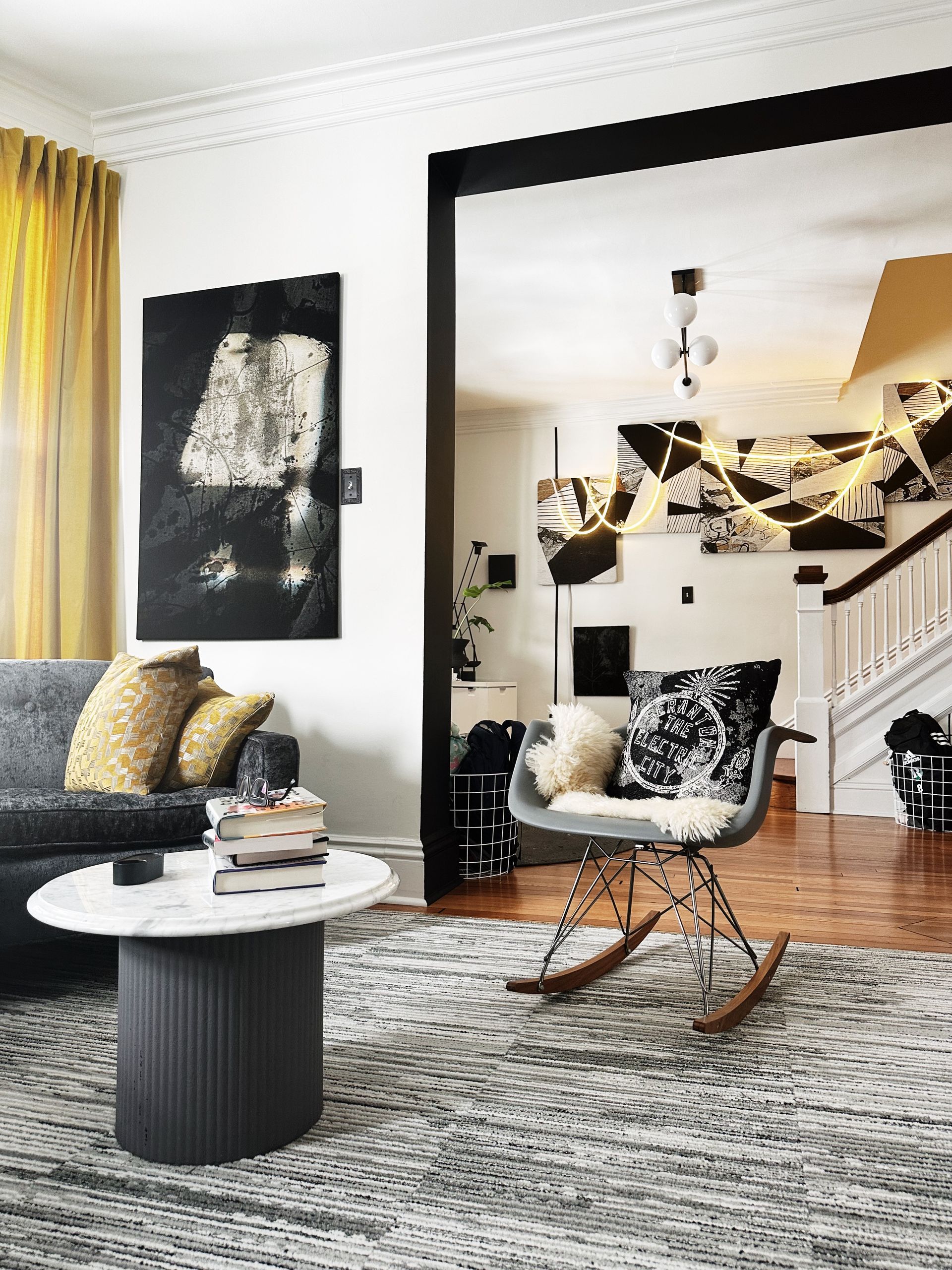 A living room with a rocking chair and a couch