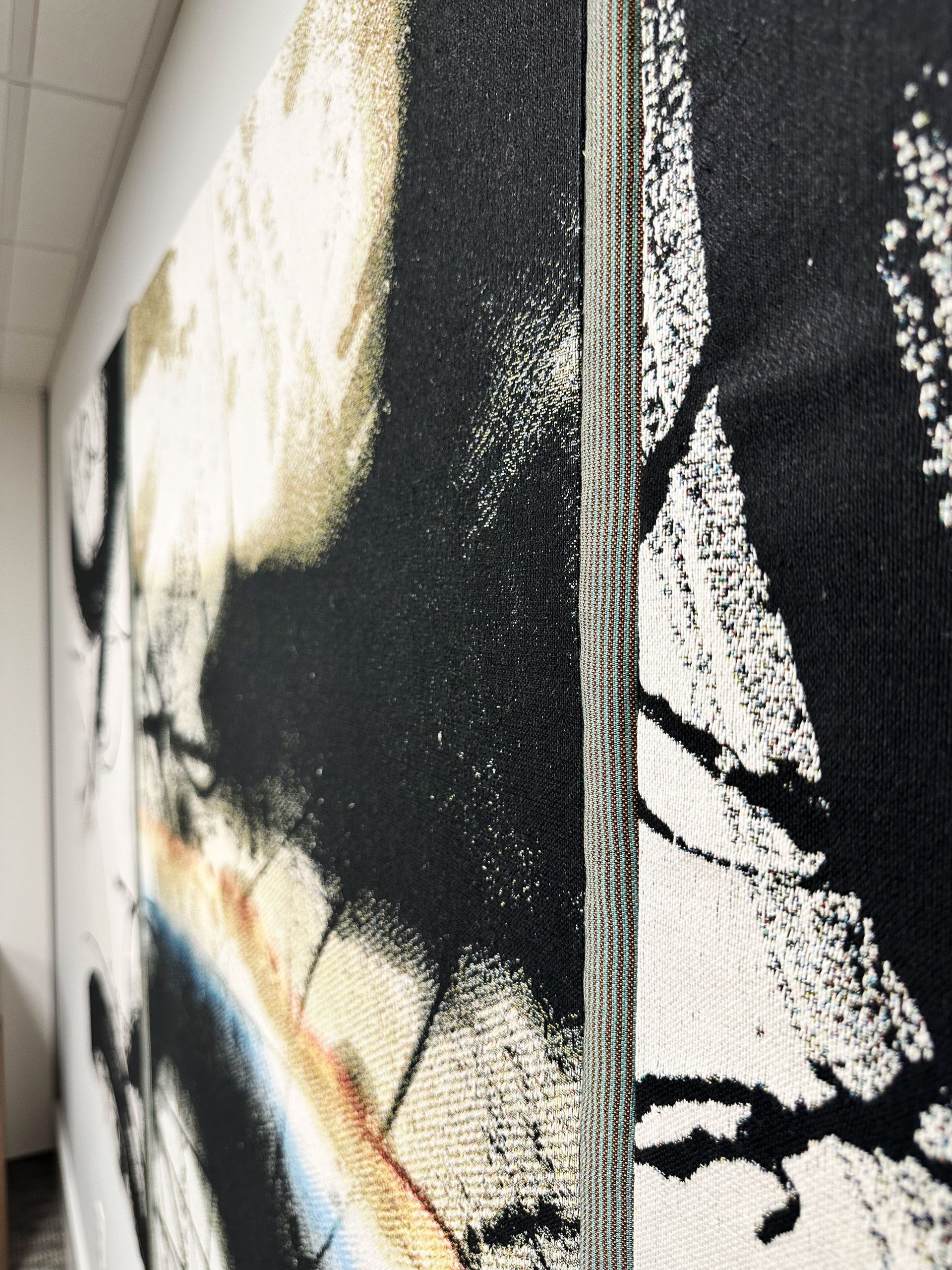 A black and white painting on a wall in a hallway