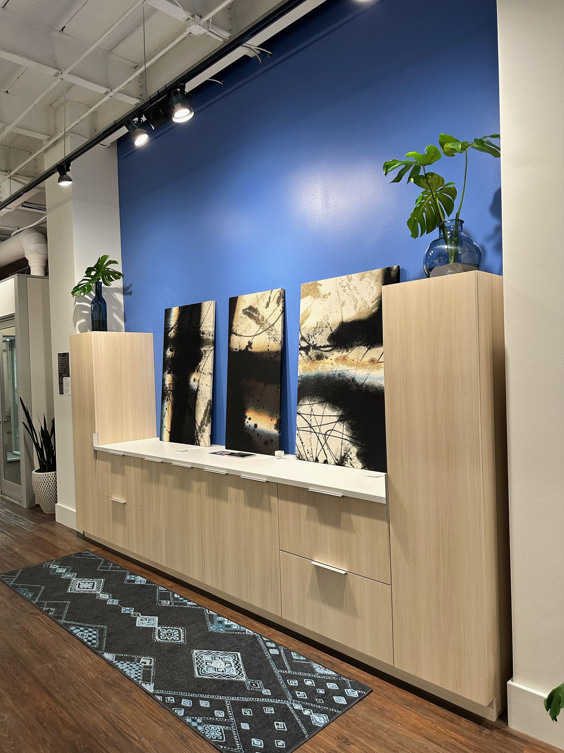 A room with a blue wall and a yoga mat on the floor