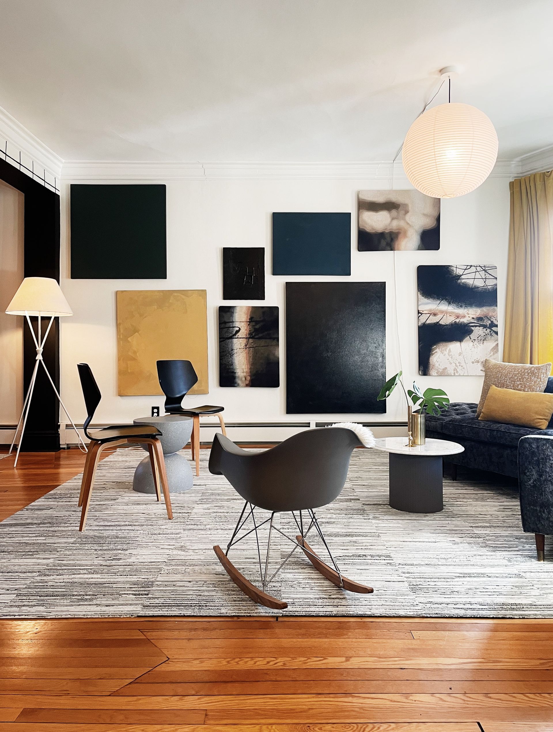 A living room with a rocking chair and a rug