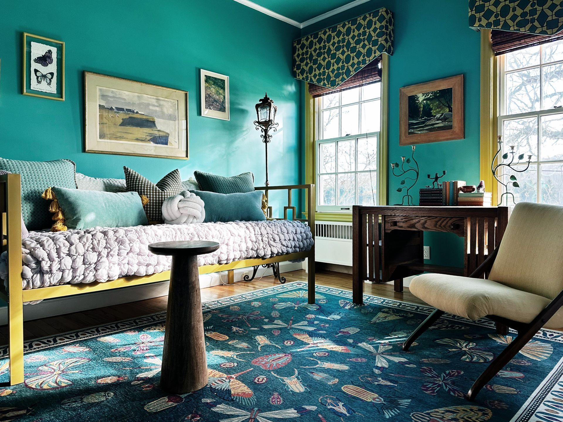 A living room with blue walls and a couch and chair