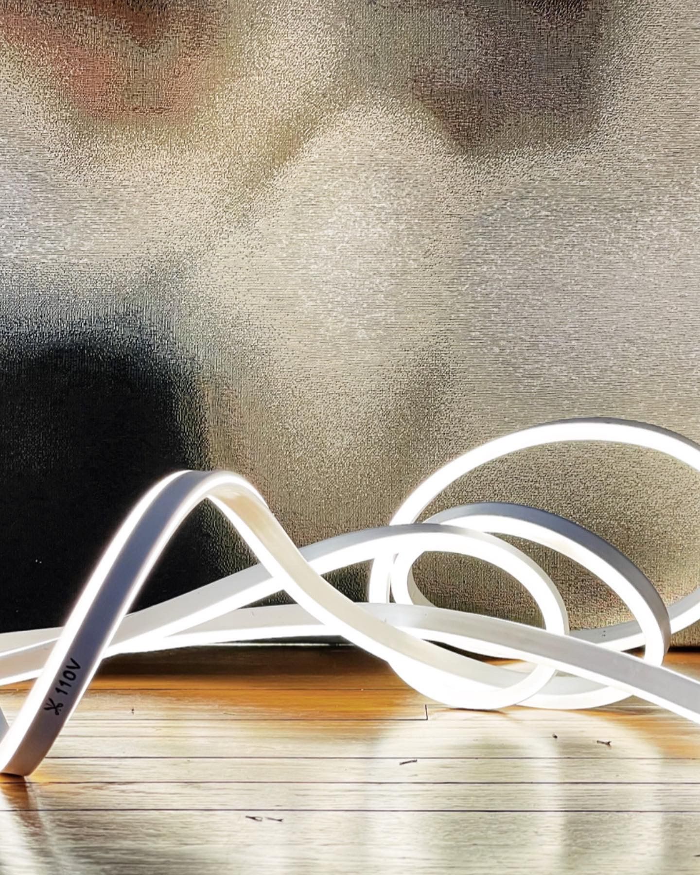 A white light is sitting on a wooden table.