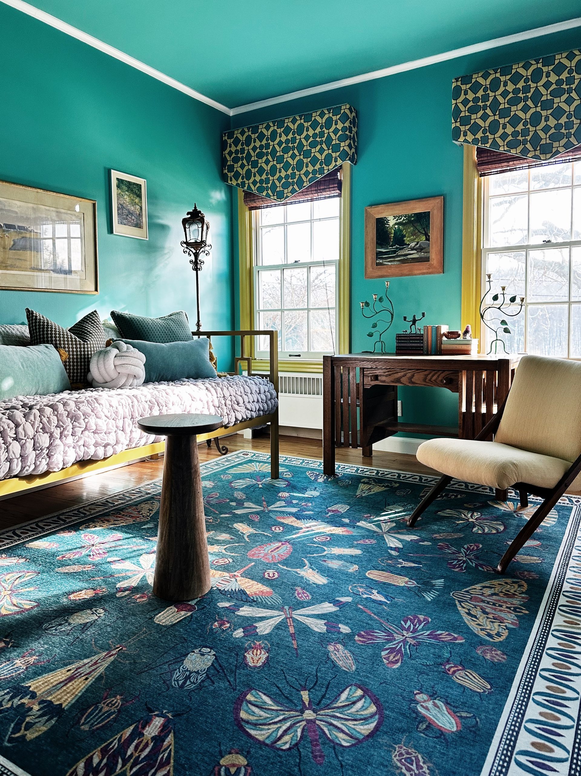 A living room with blue walls and a blue rug