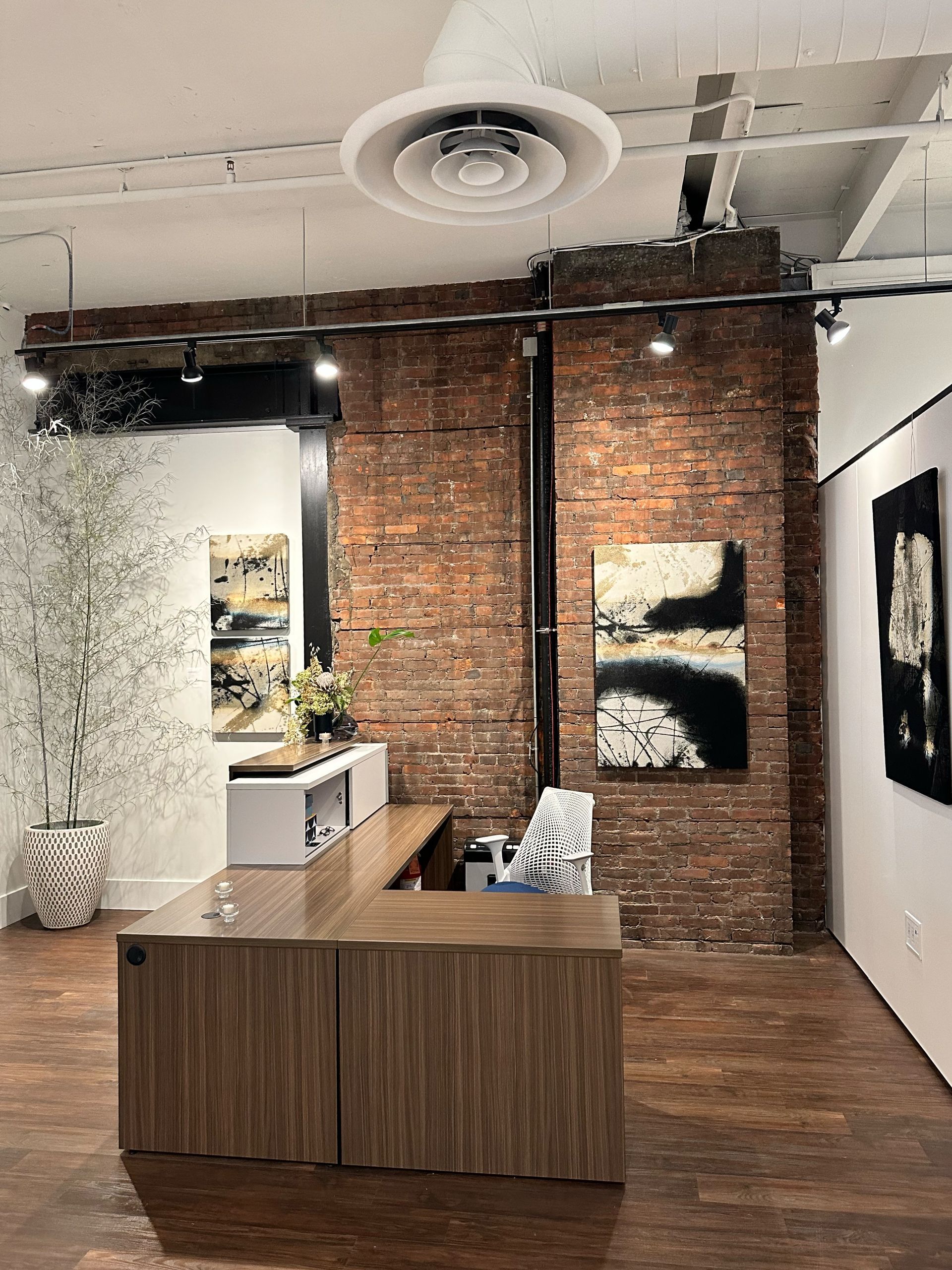 A room with a brick wall and a wooden table