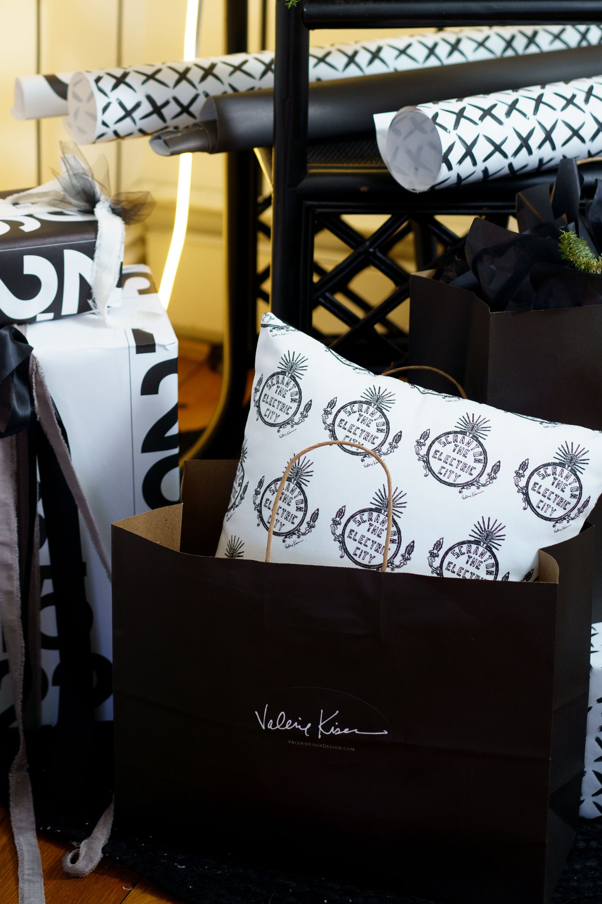 A pillow with pineapples on it sits in a black box