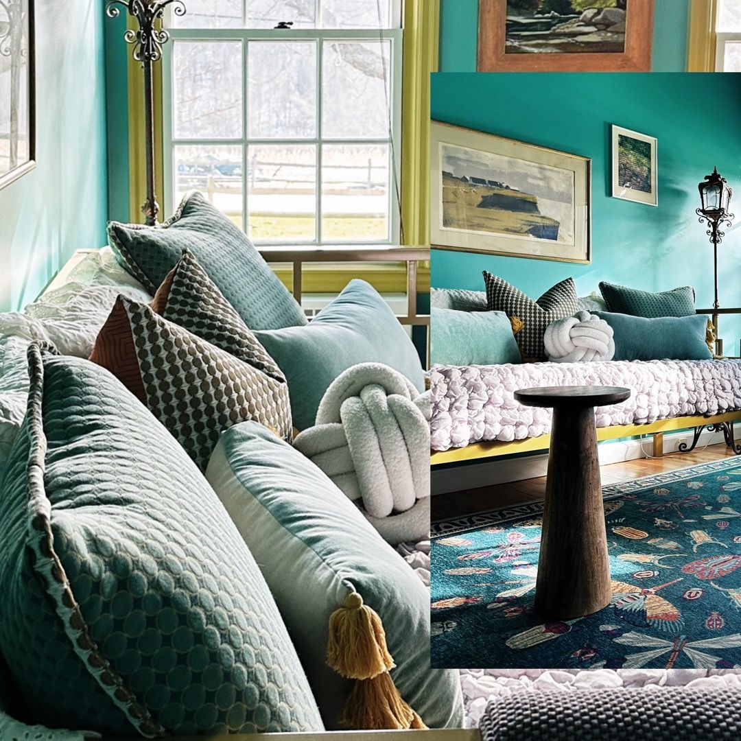 A living room with a couch and pillows and a table