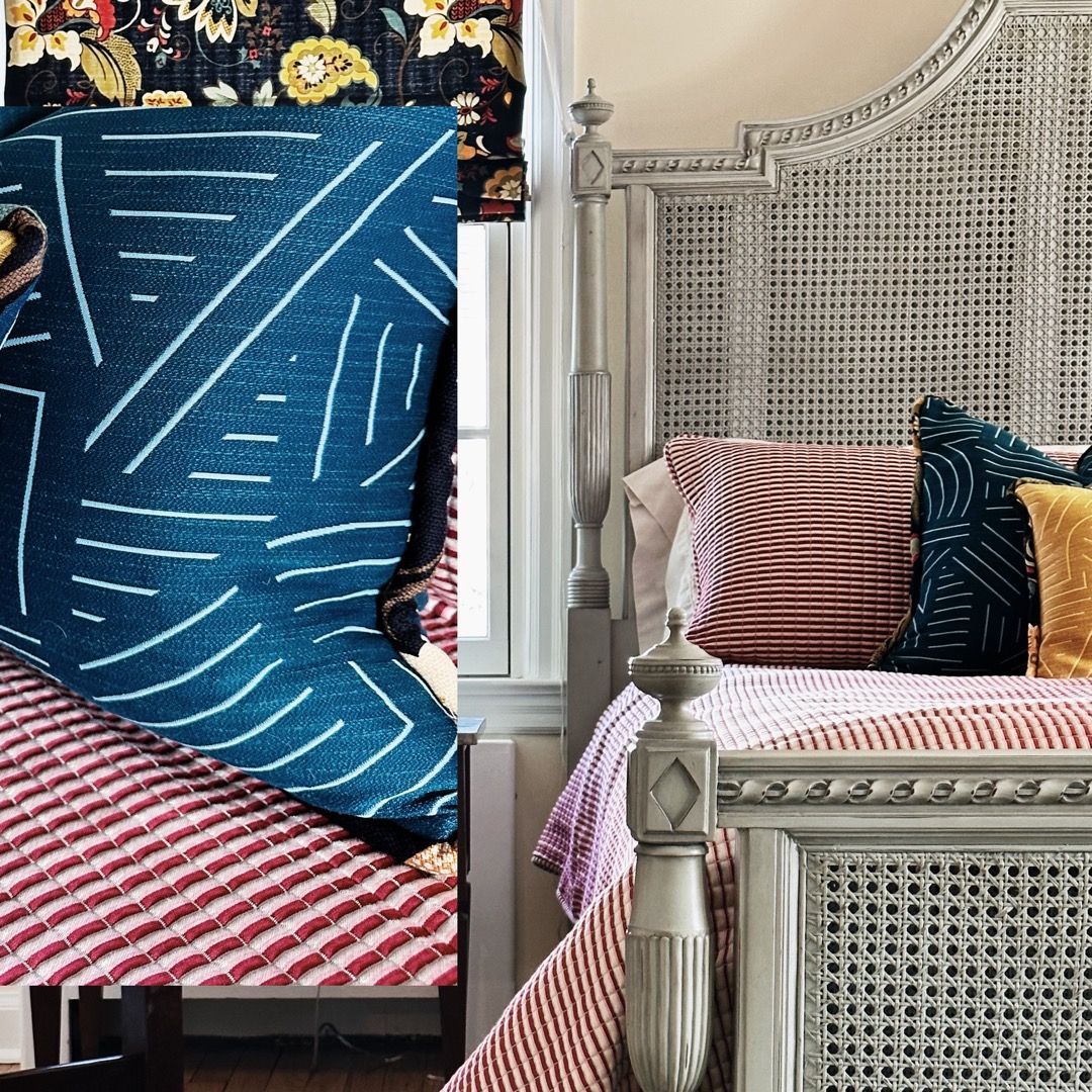 A bed with a blanket and pillows on it in a bedroom.