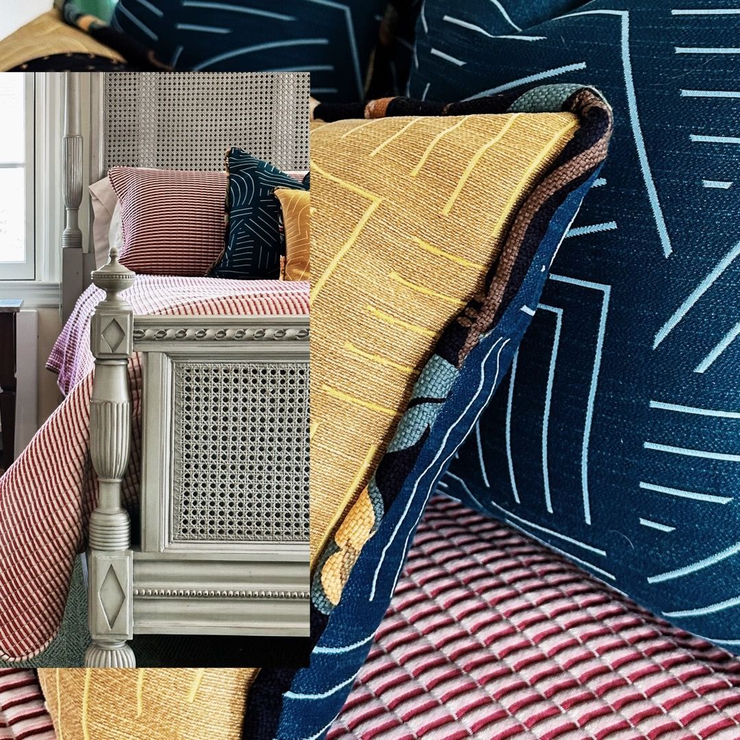 A bed with many pillows and blankets on it