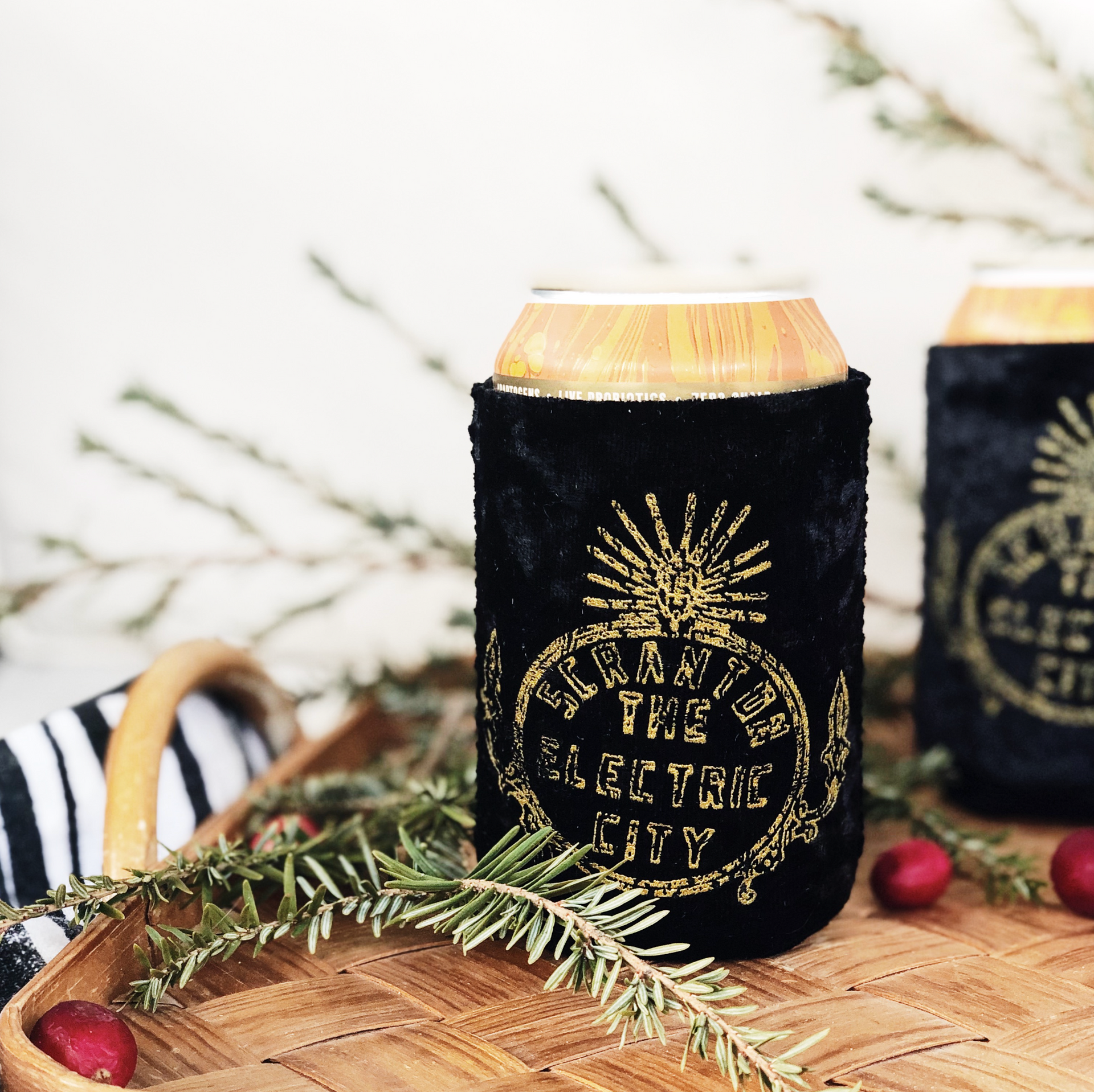 A black can holder with a pineapple on it