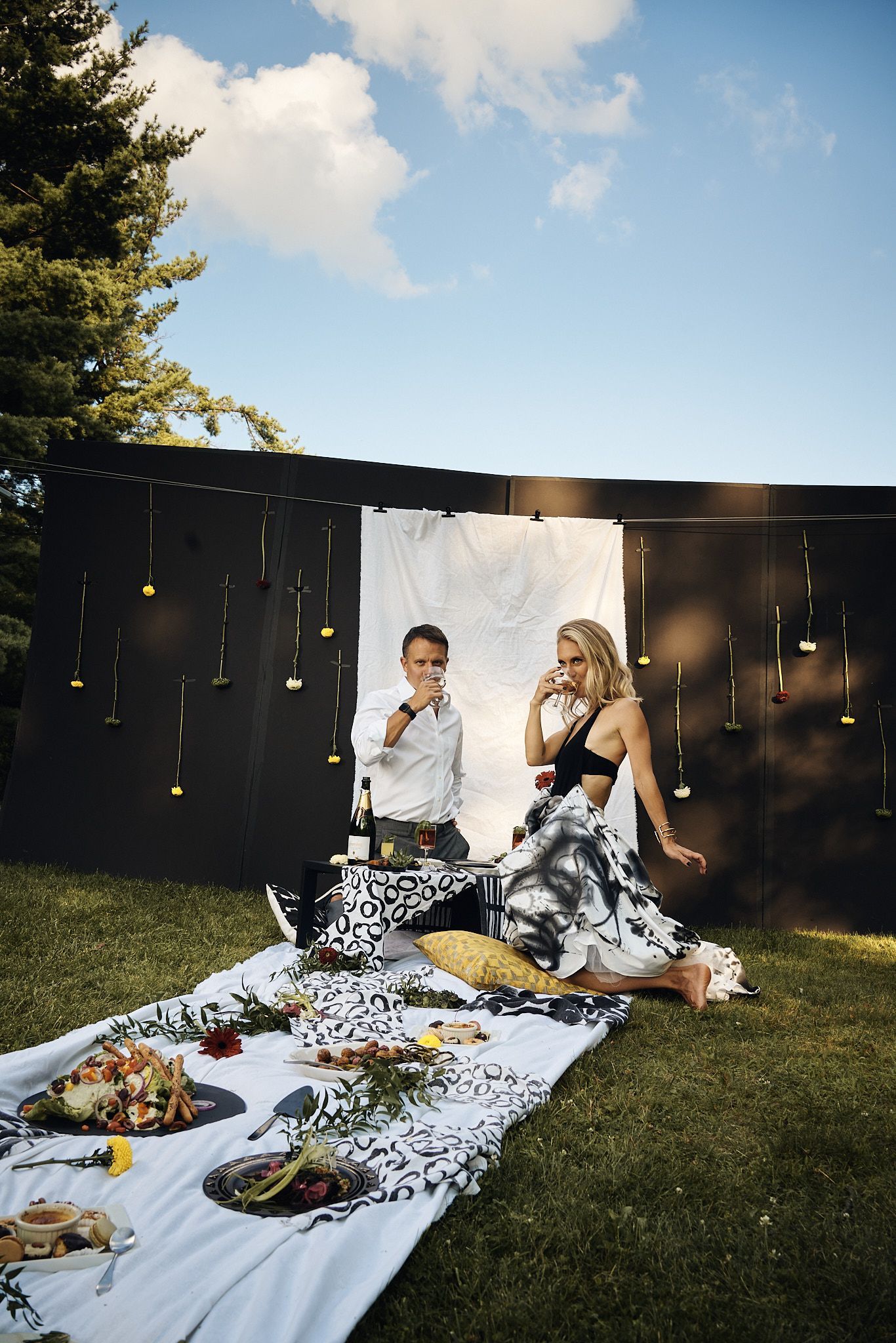 A man and a woman are having a picnic in the grass.