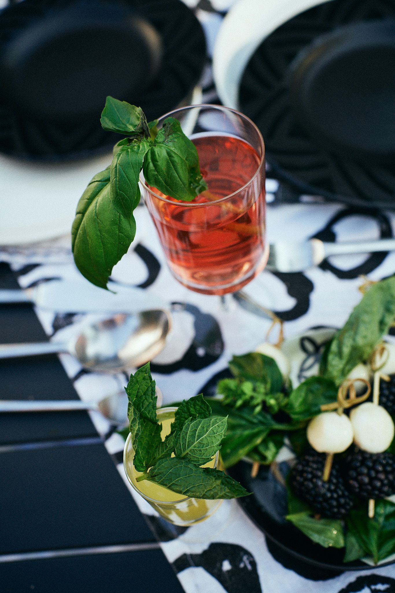 A glass of wine is sitting on a table next to a plate of food.