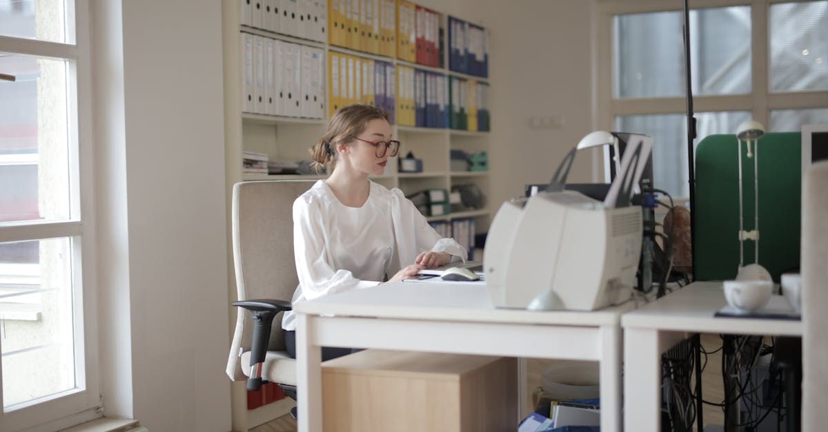 Twin Oaks image – young woman with glasses working at a desk on a computer, illustrating bookkeeping and accounting services.