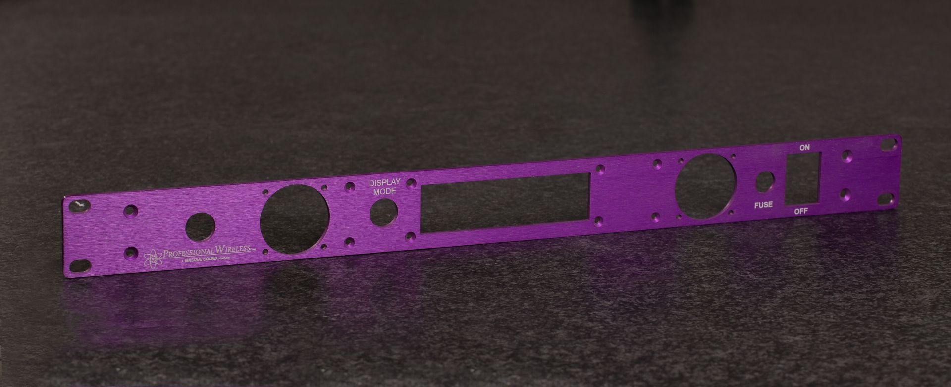 A purple piece of metal is sitting on the floor.