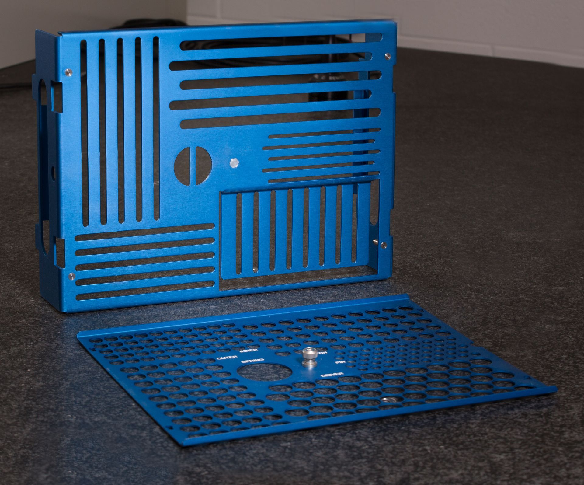 A blue metal item with a hole in the middle