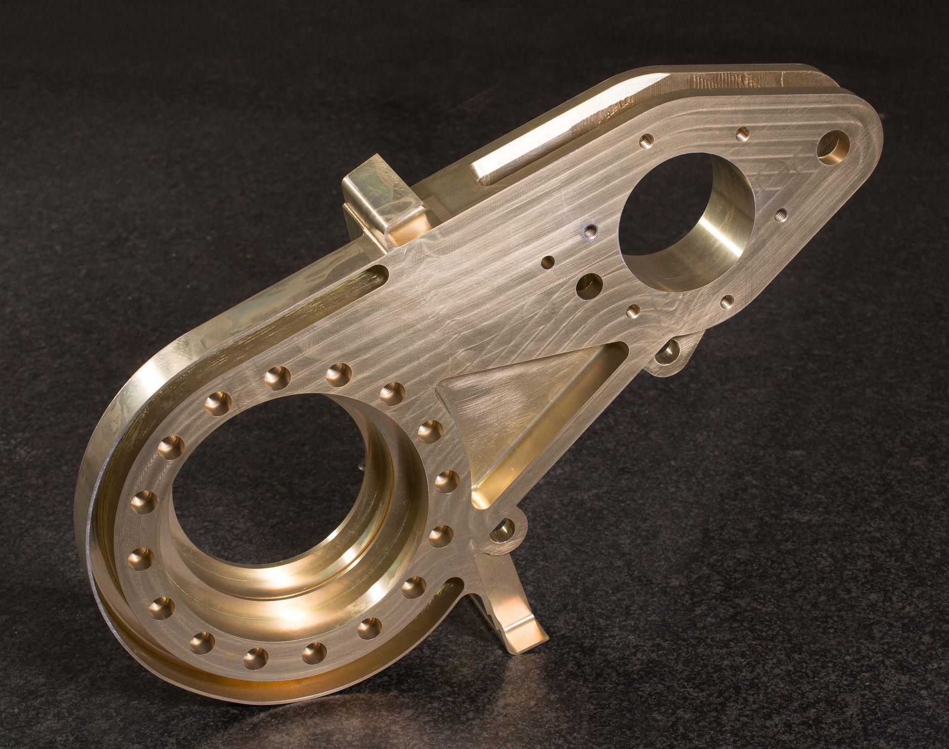 A piece of metal with holes in it is sitting on a table