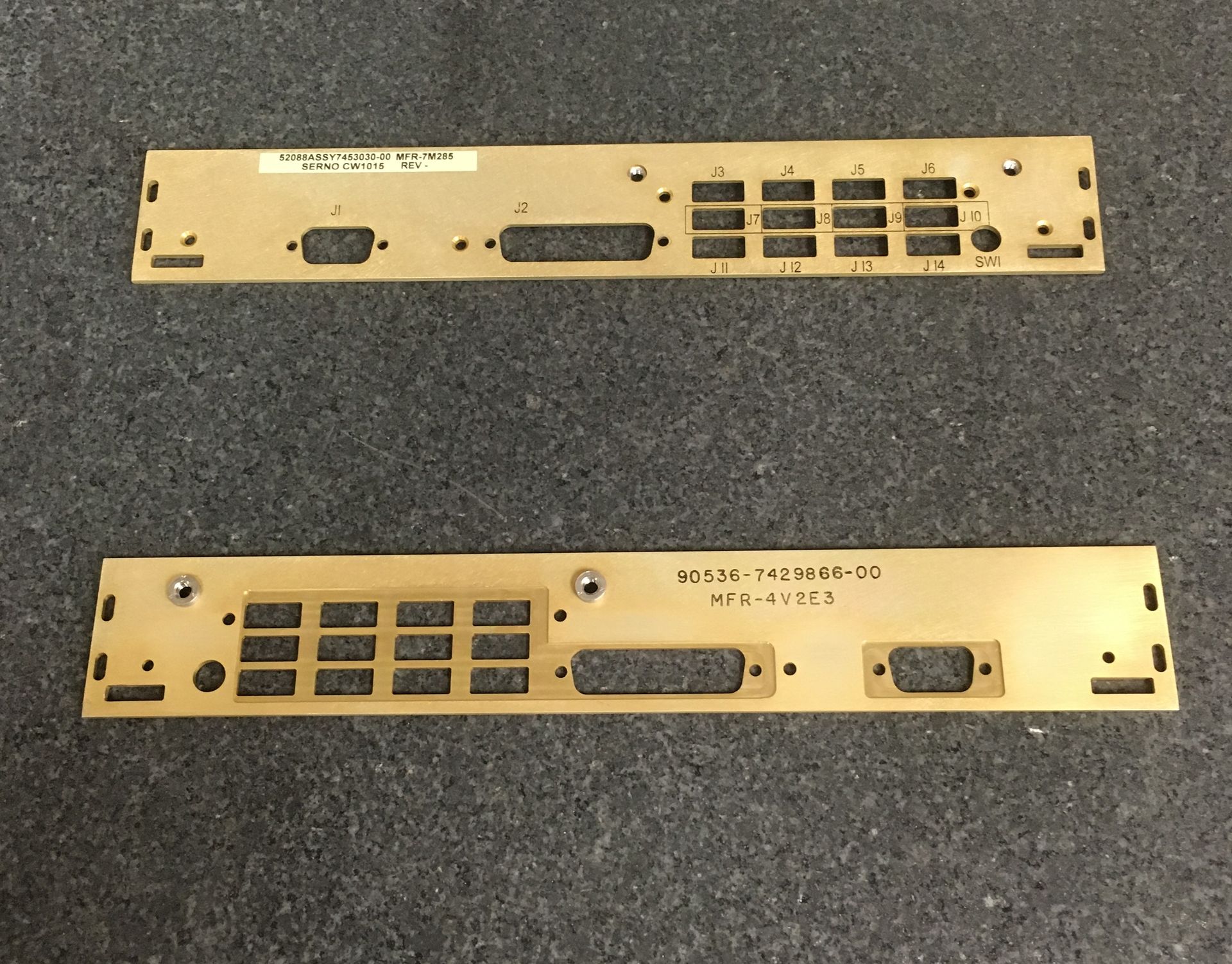 A pair of brass plates with numbers on them