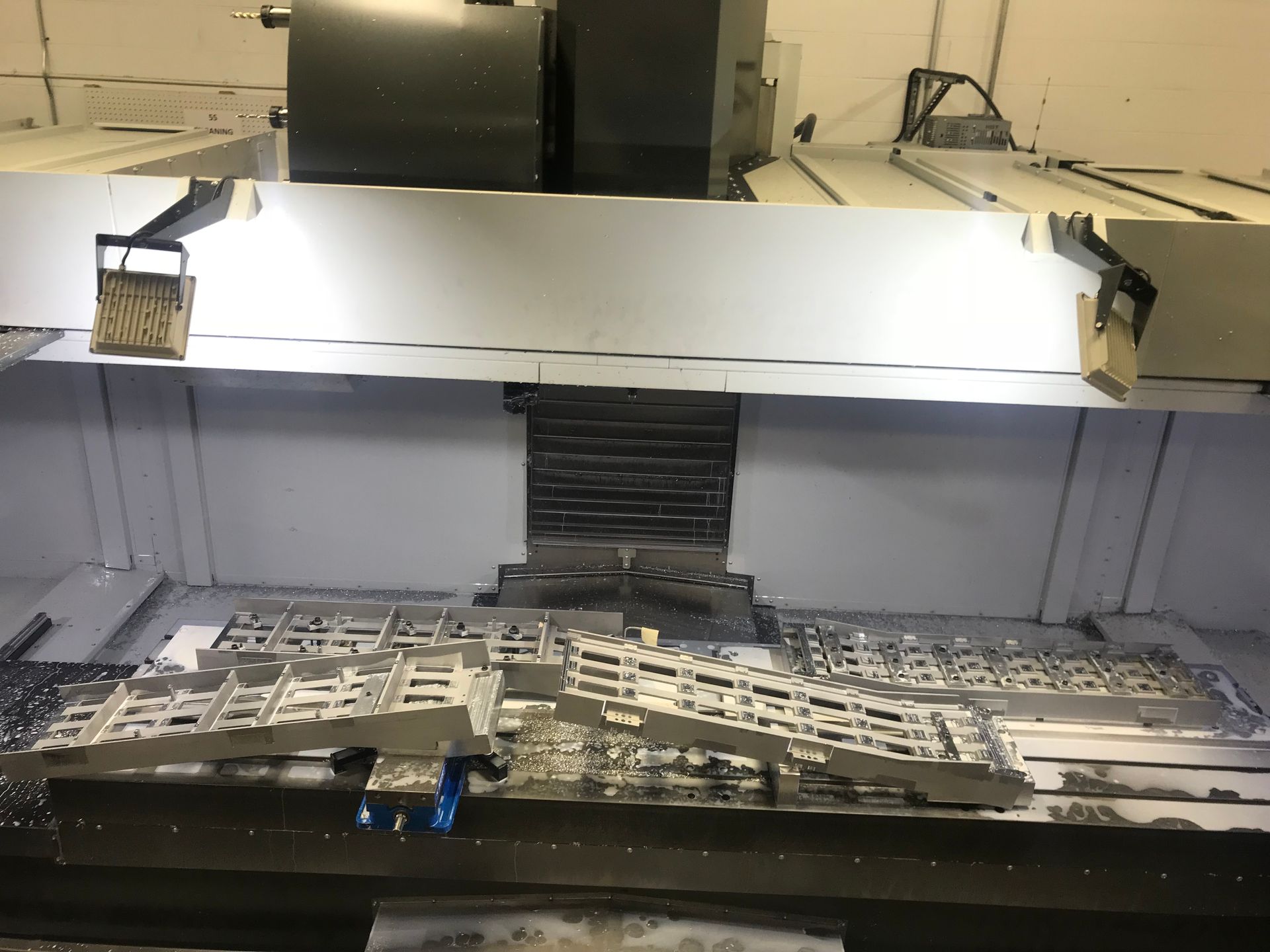 A machine is being used to make a piece of metal