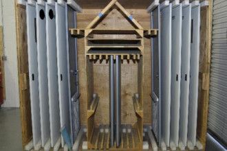 A wooden box filled with a bunch of white boxes.