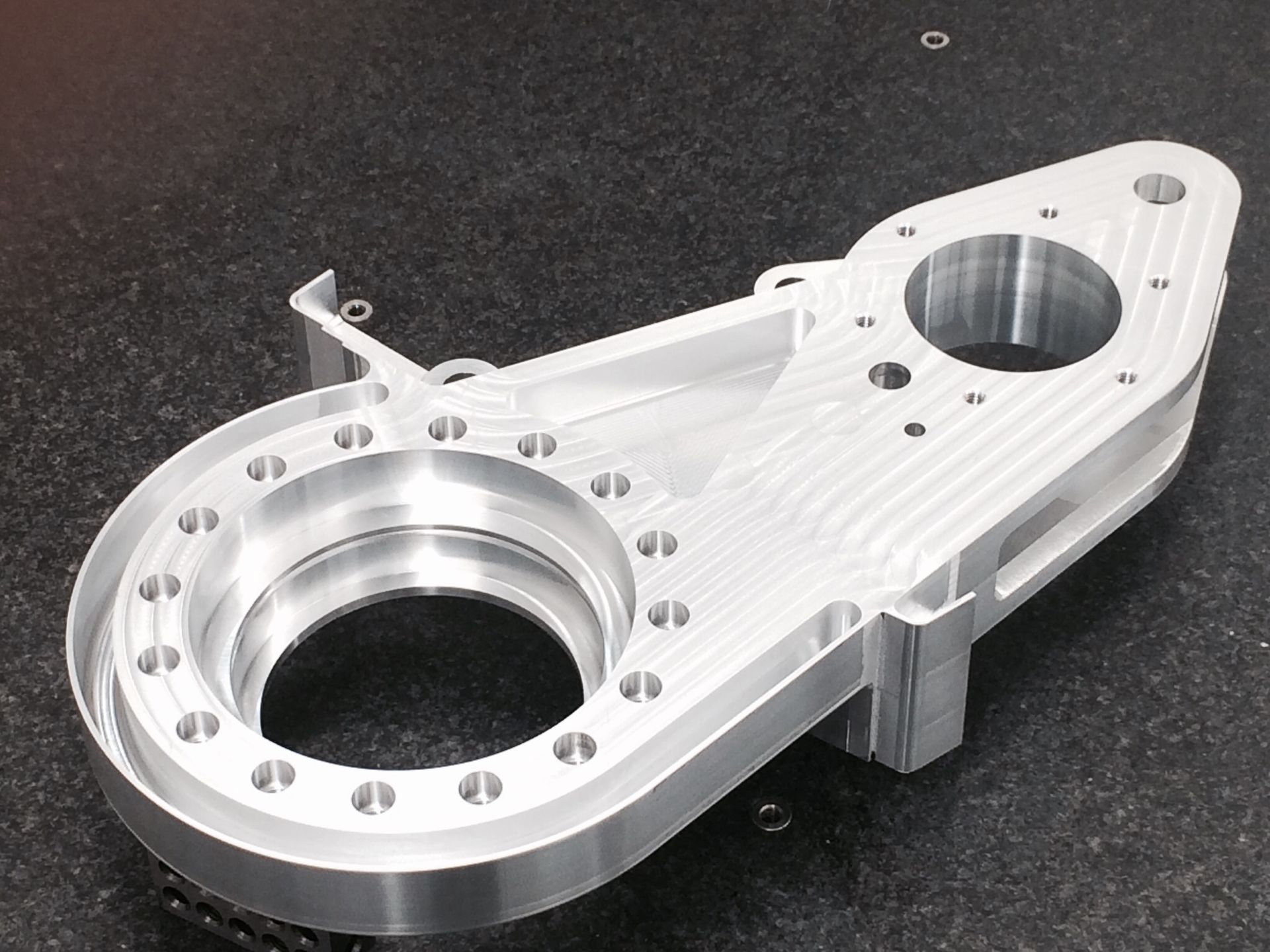 A piece of metal with holes in it is sitting on a table