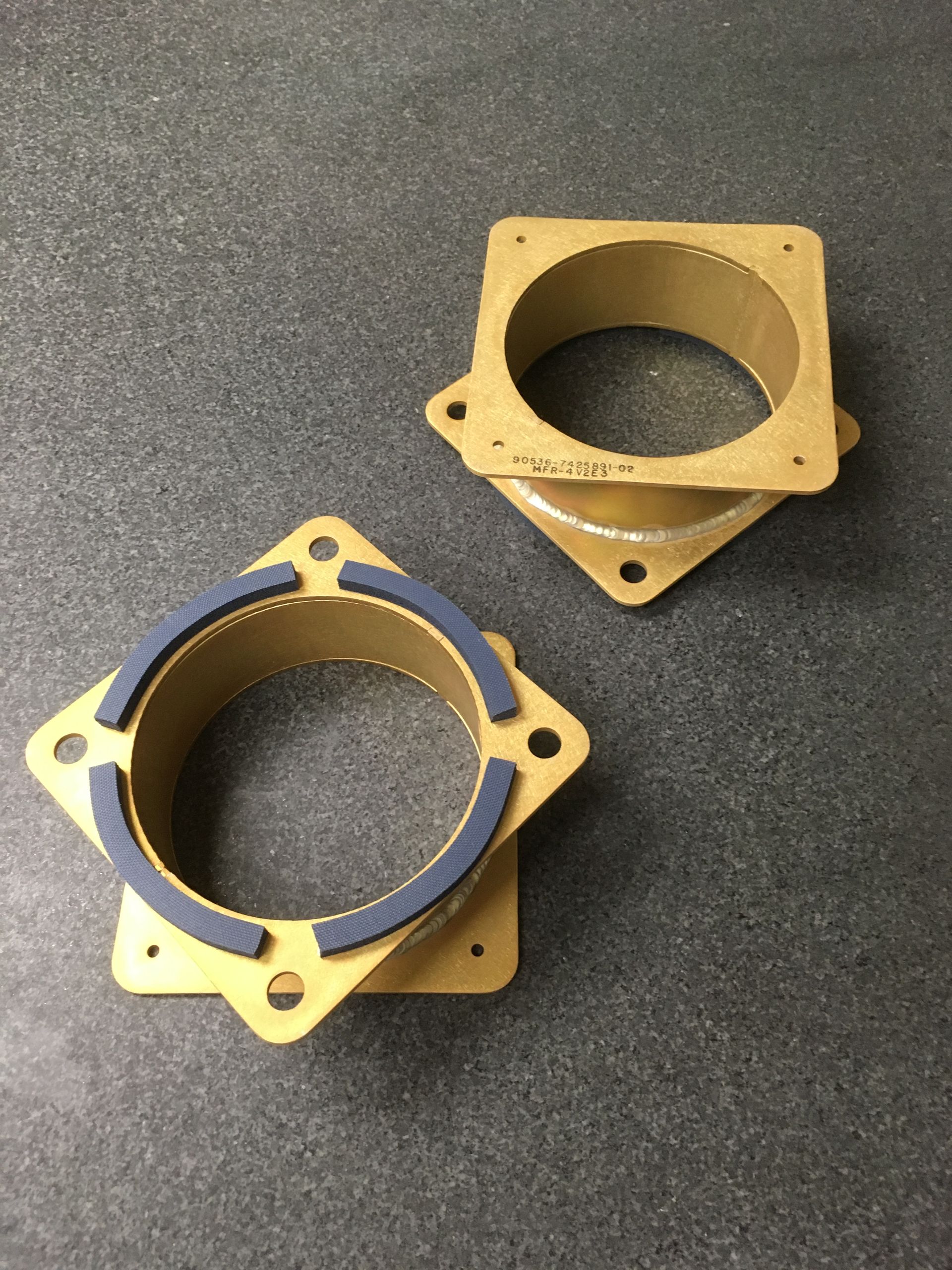 A pair of cardboard rings with foam on them are sitting on a table.