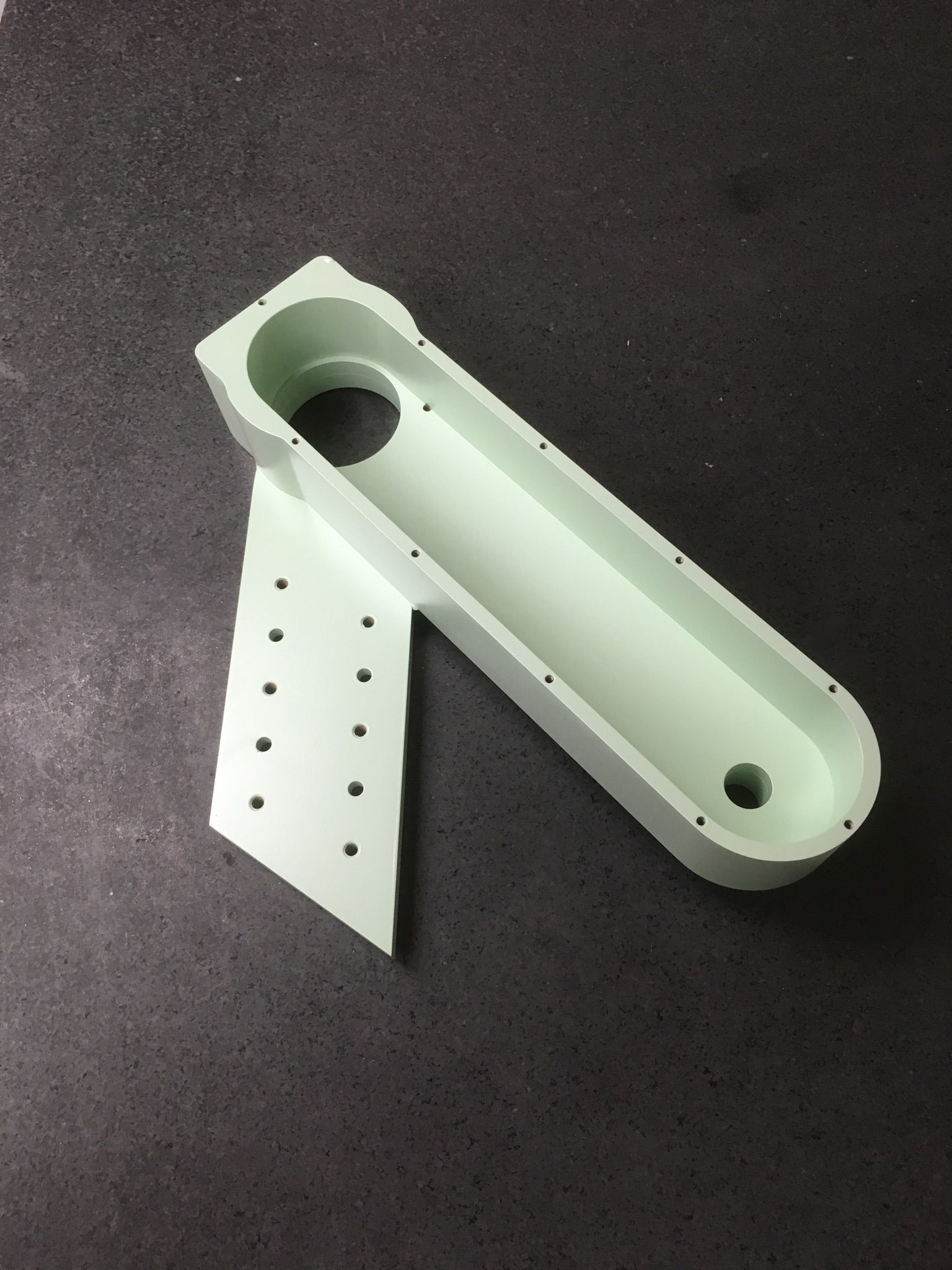 A piece of white plastic with holes in it