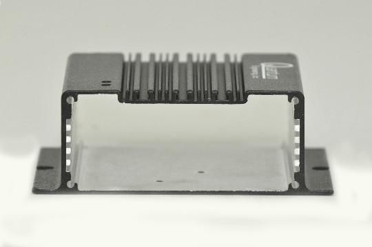 A black box with a clear lid is sitting on a white surface.