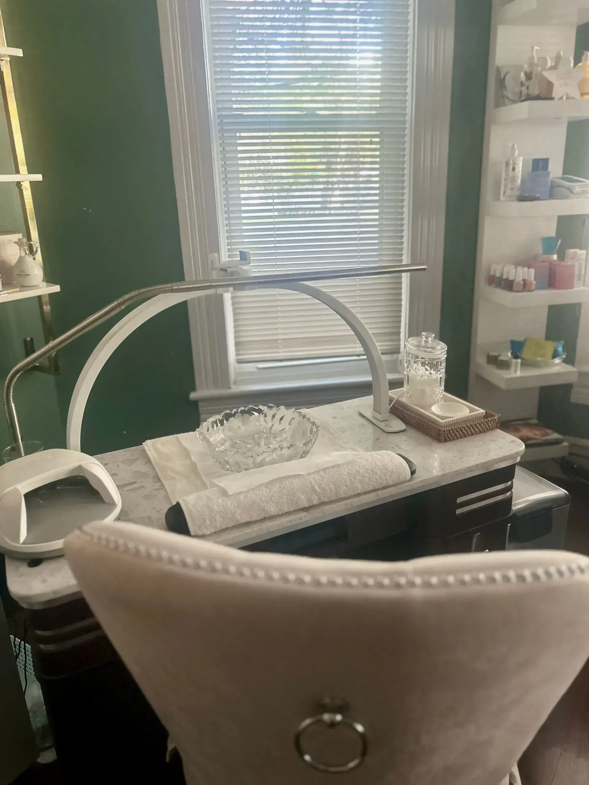 Nail salon interior with manicure table, light, and window. 