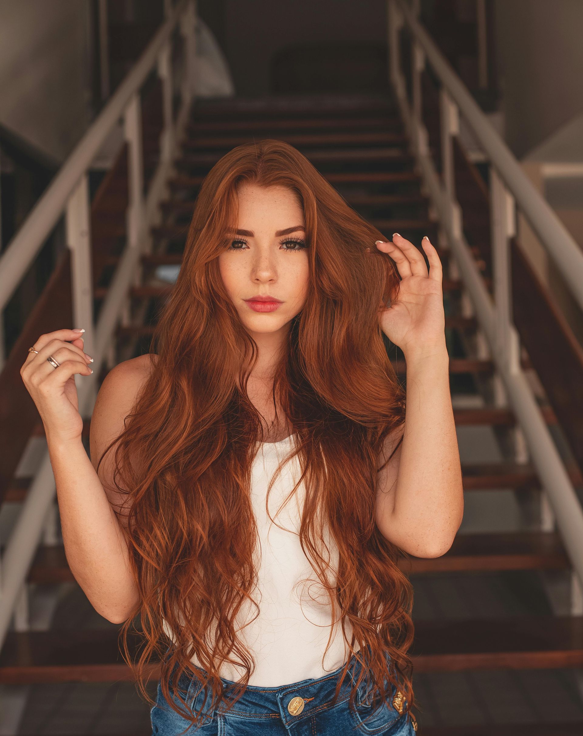 A Lady with long red healthy hair.