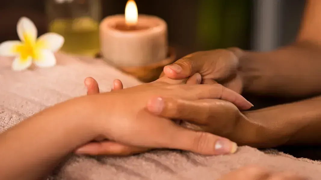 A woman is getting a hand massage at a spa.