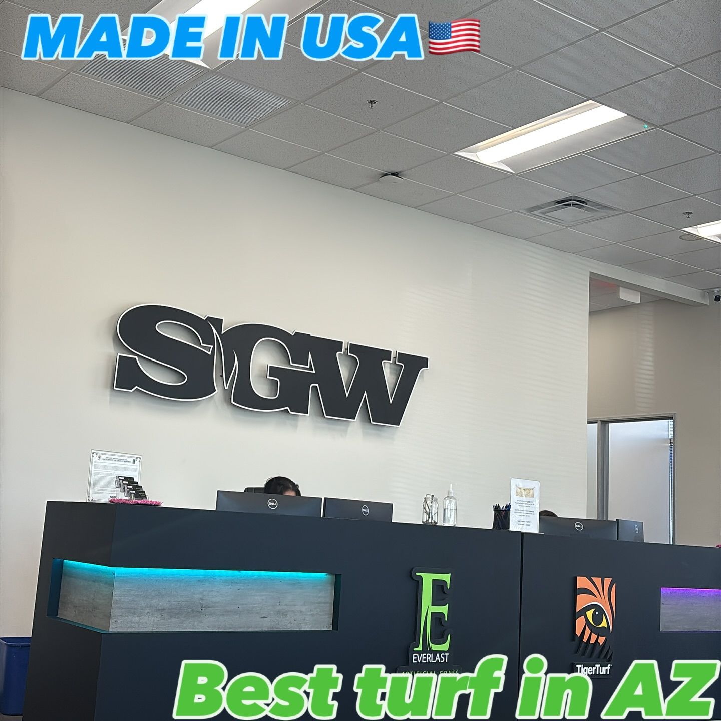 A reception desk featuring the SGW logo on a wall, with 