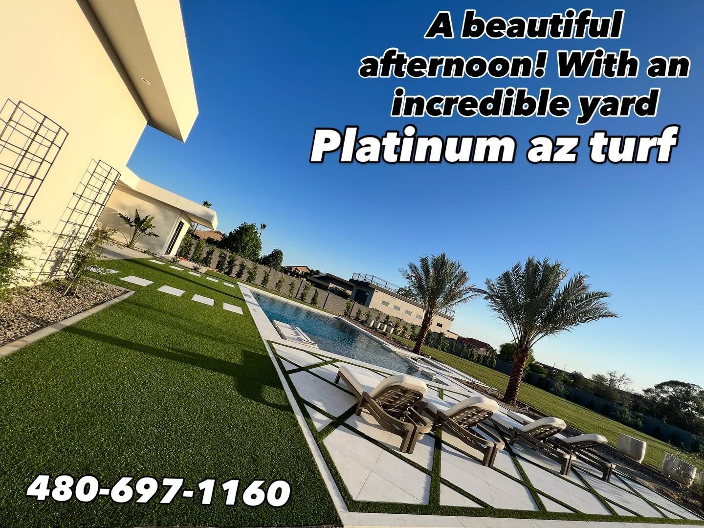 A sunny backyard with artificial grass, a swimming pool, lounge chairs, and palm trees. Text: Platinum az turf 480-697-1160.