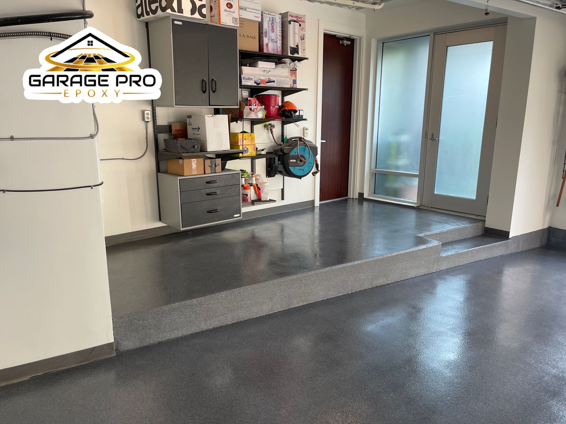 A garage with a gray floor and a sign that says garage pro