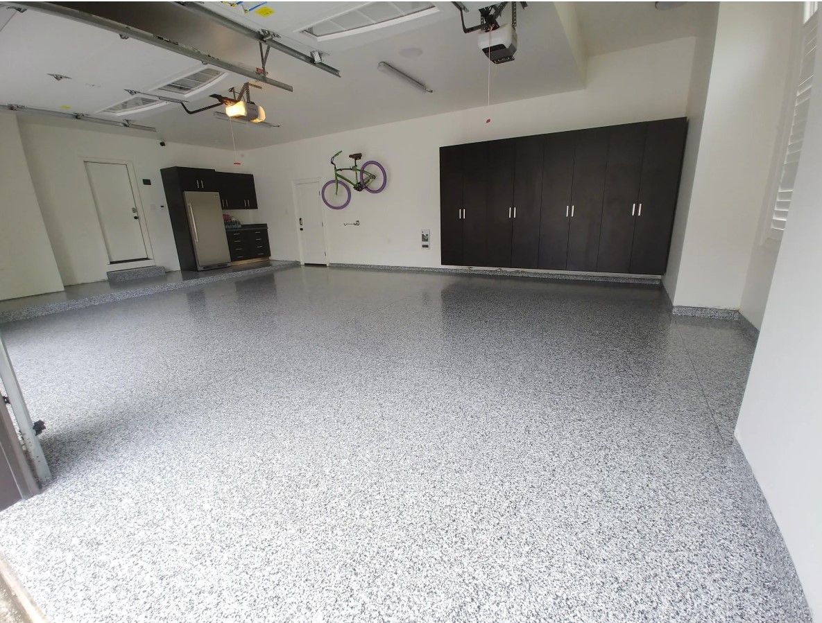A garage with a bicycle hanging on the wall.