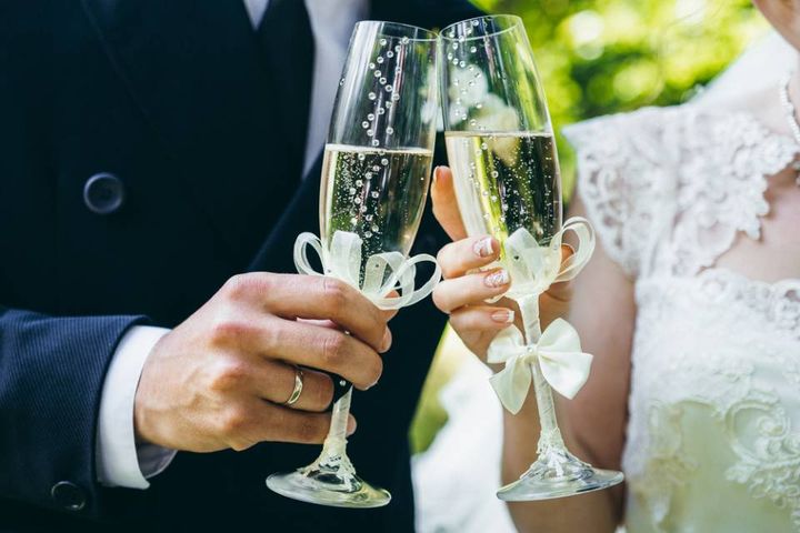 bride and groom with wine glasses