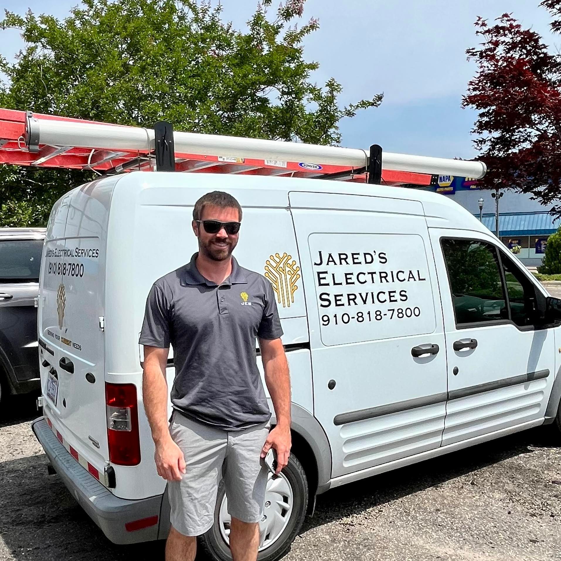 A man is standing in front of a white van.