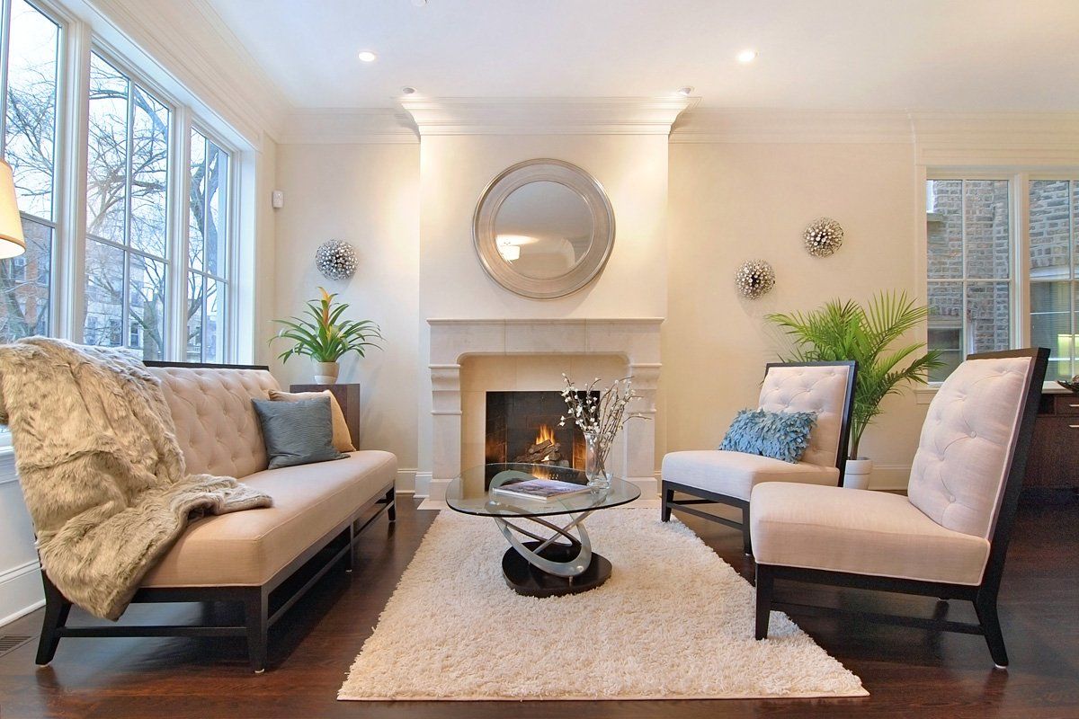 A living room with a couch and chairs and a fireplace
