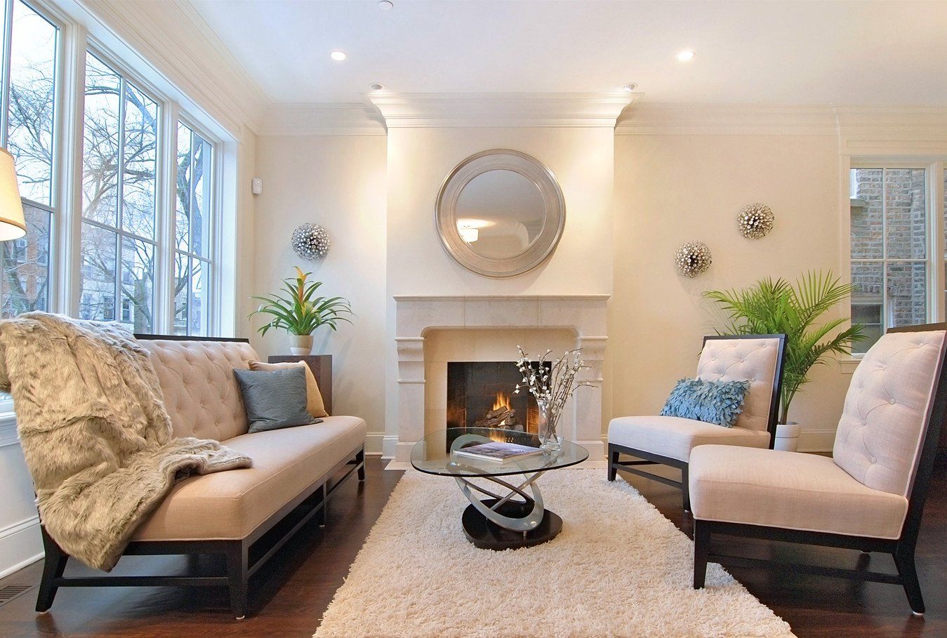 A living room with a couch and chairs and a fireplace