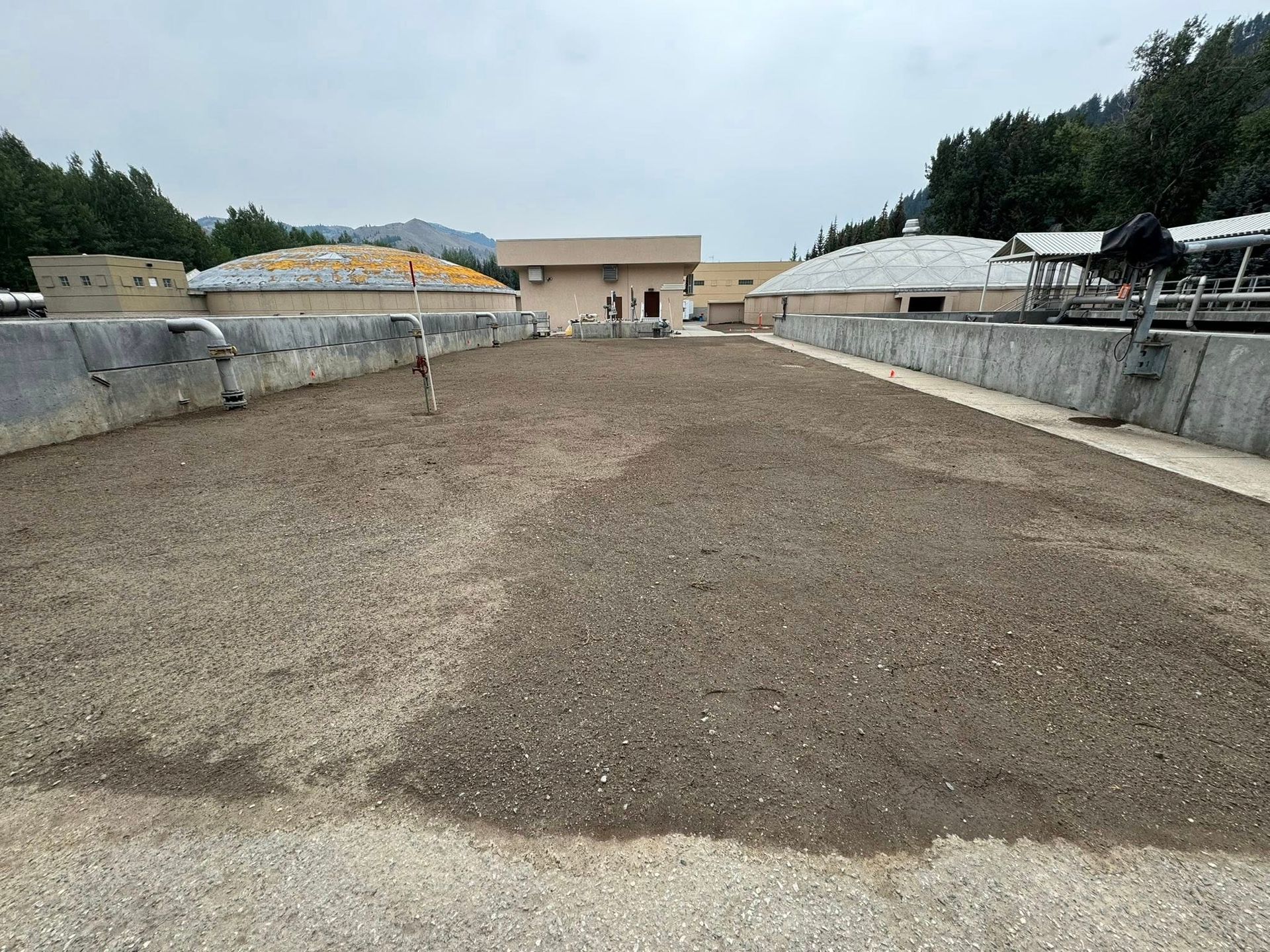 Modern kitchen with glossy gray cabinets, beige backsplash, and warm under-cabinet lighting.