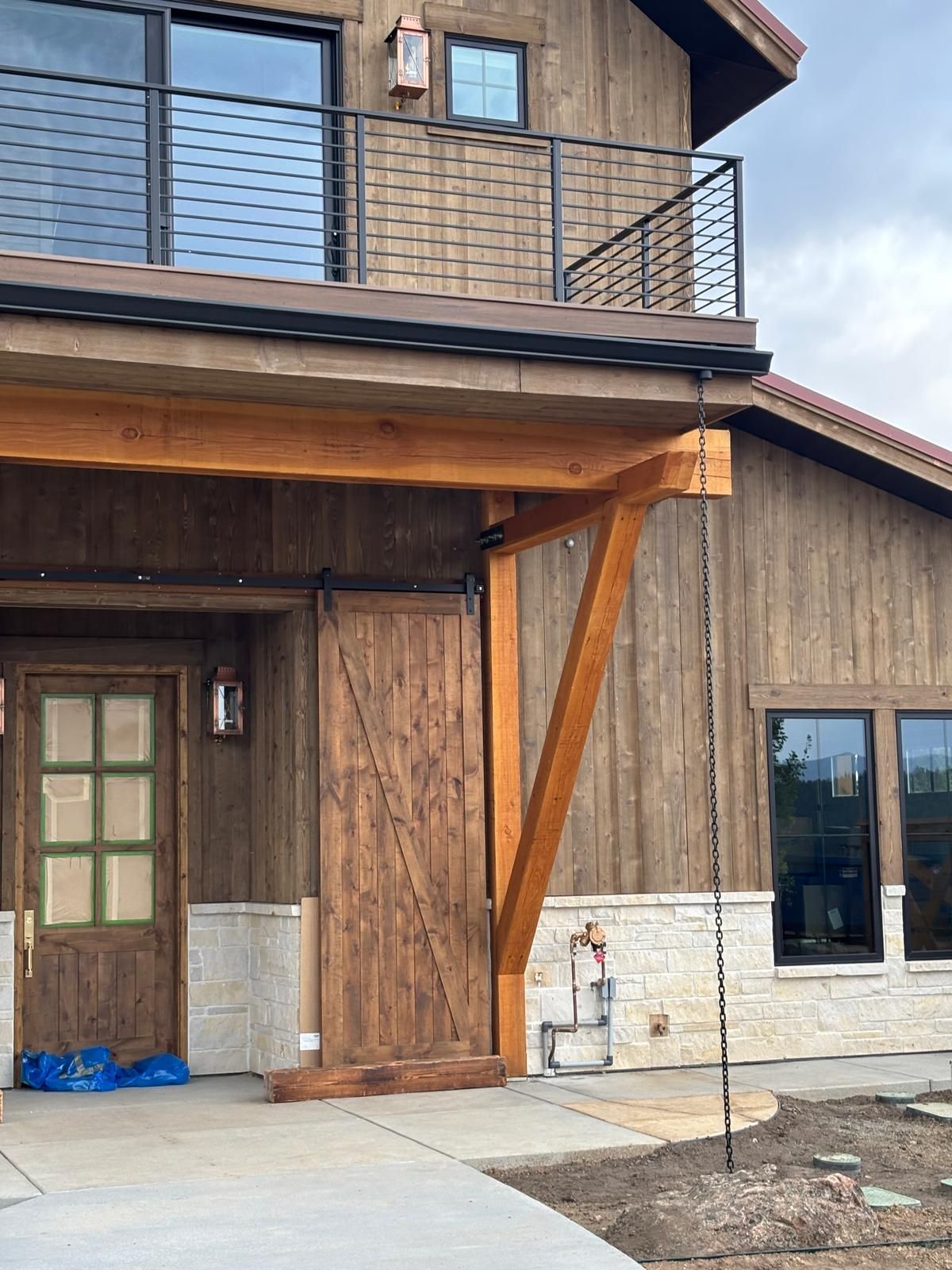 A mobile home with a porch and a swing in the backyard.