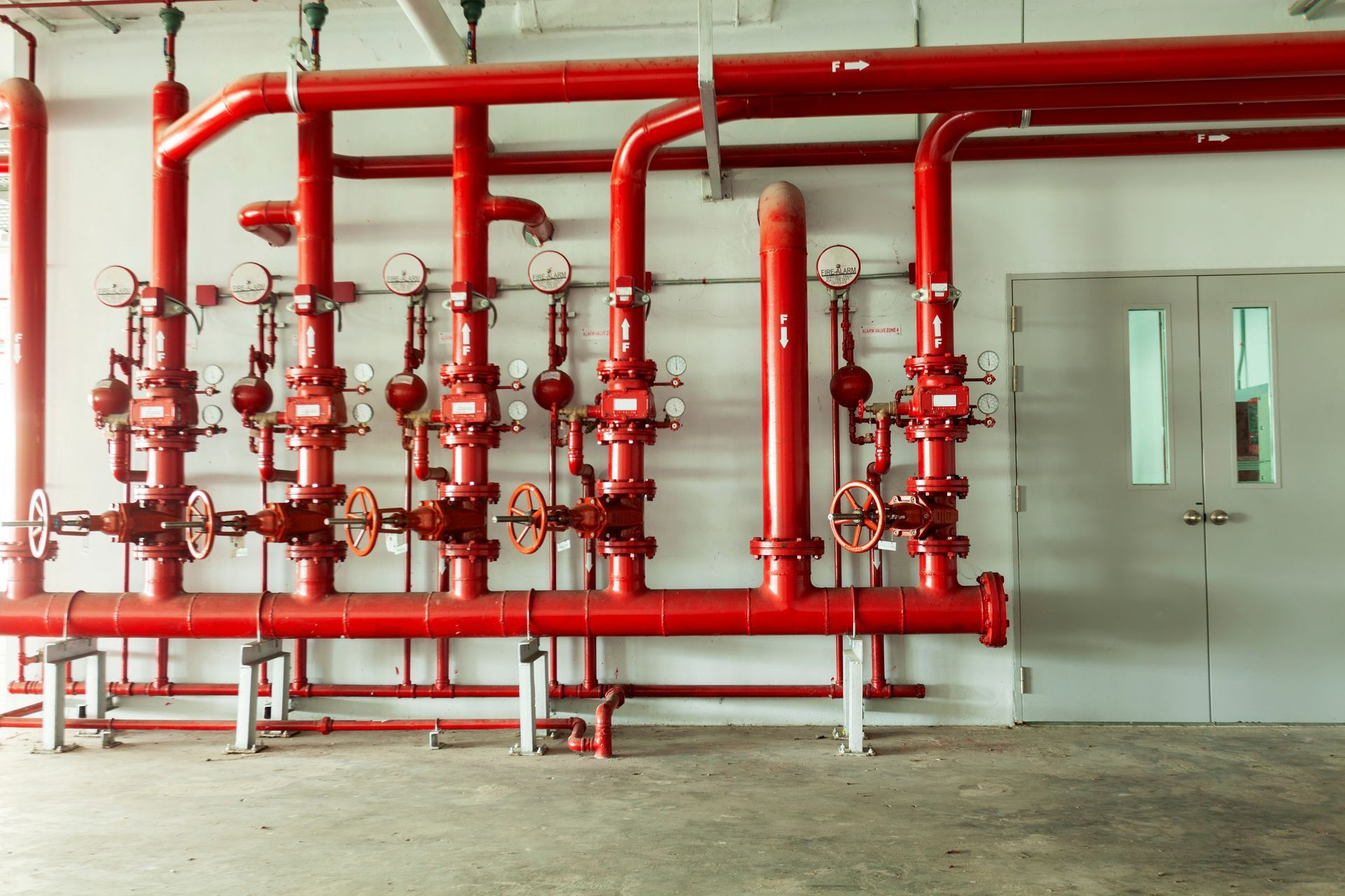 A room filled with lots of red pipes and valves.
