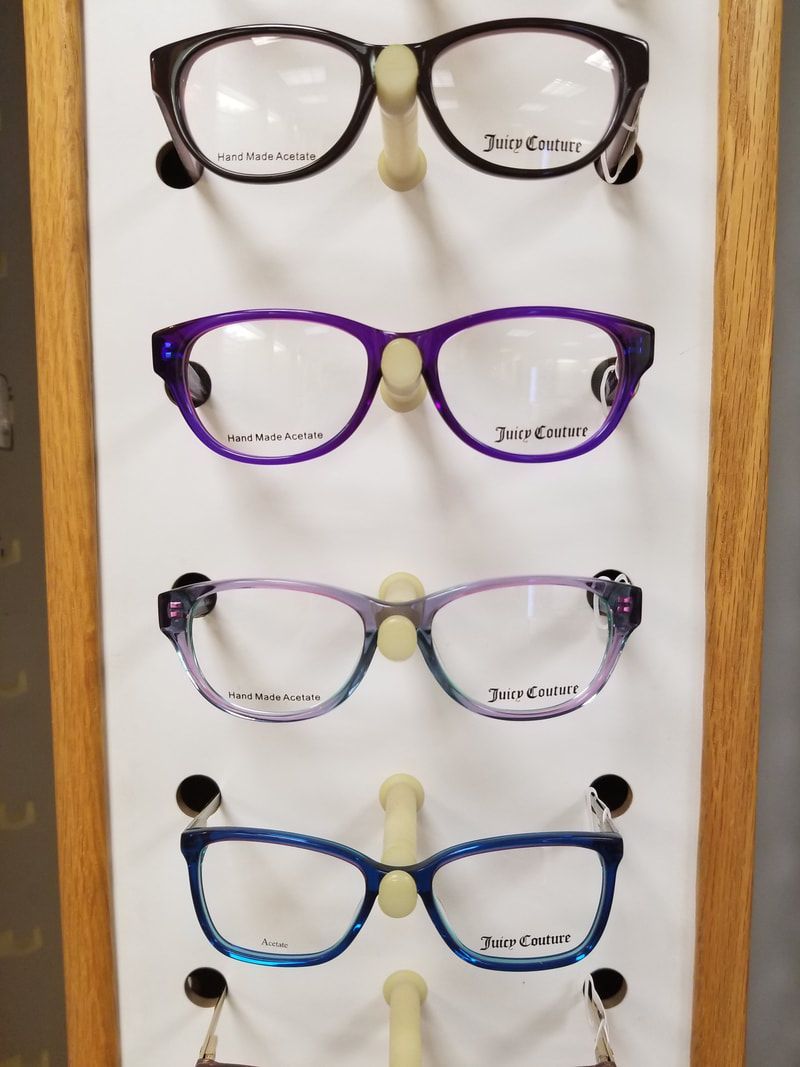 Several pairs of glasses are displayed on a stand