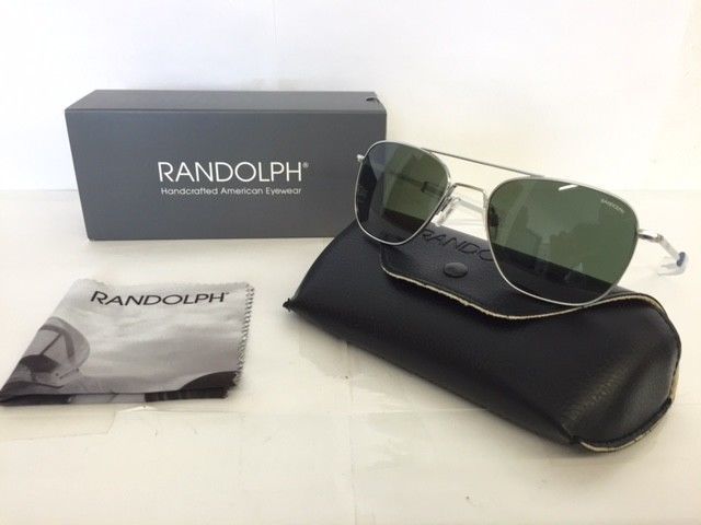 A pair of sunglasses sitting next to a randolph box