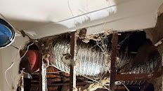 A smoking electrical outlet with a white plug. Two red switches are on either side.