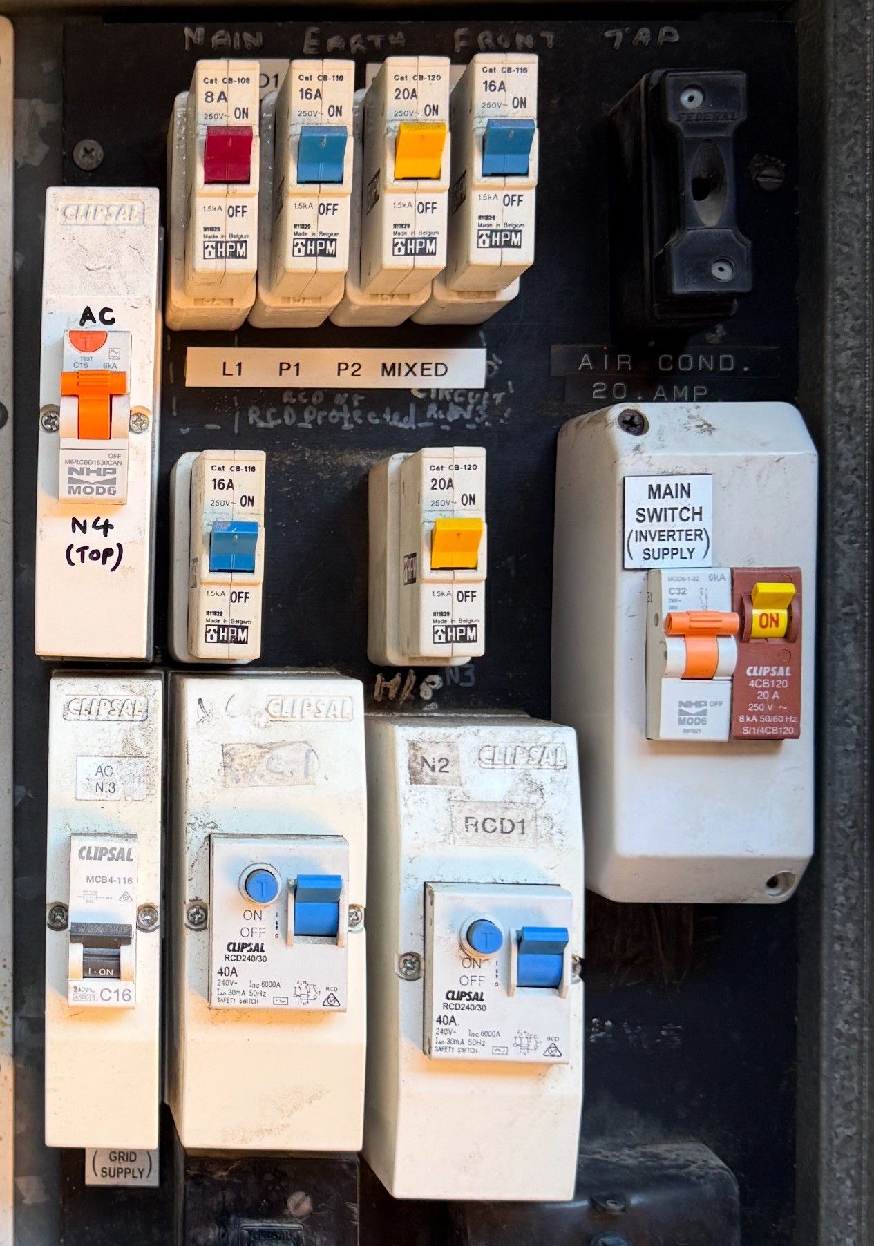 Electrician testing electrical panel with a multimeter, wearing work gloves. Electrician testing electrical panel with a multimeter, wearing work gloves.