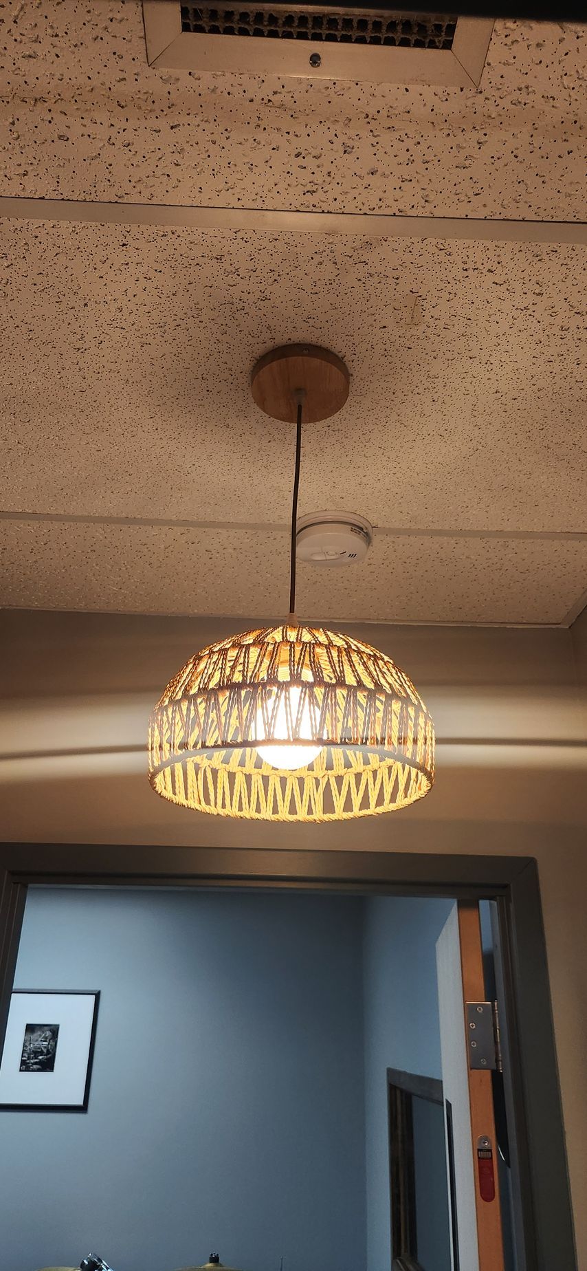 A pendant light is hanging from the ceiling in a room.