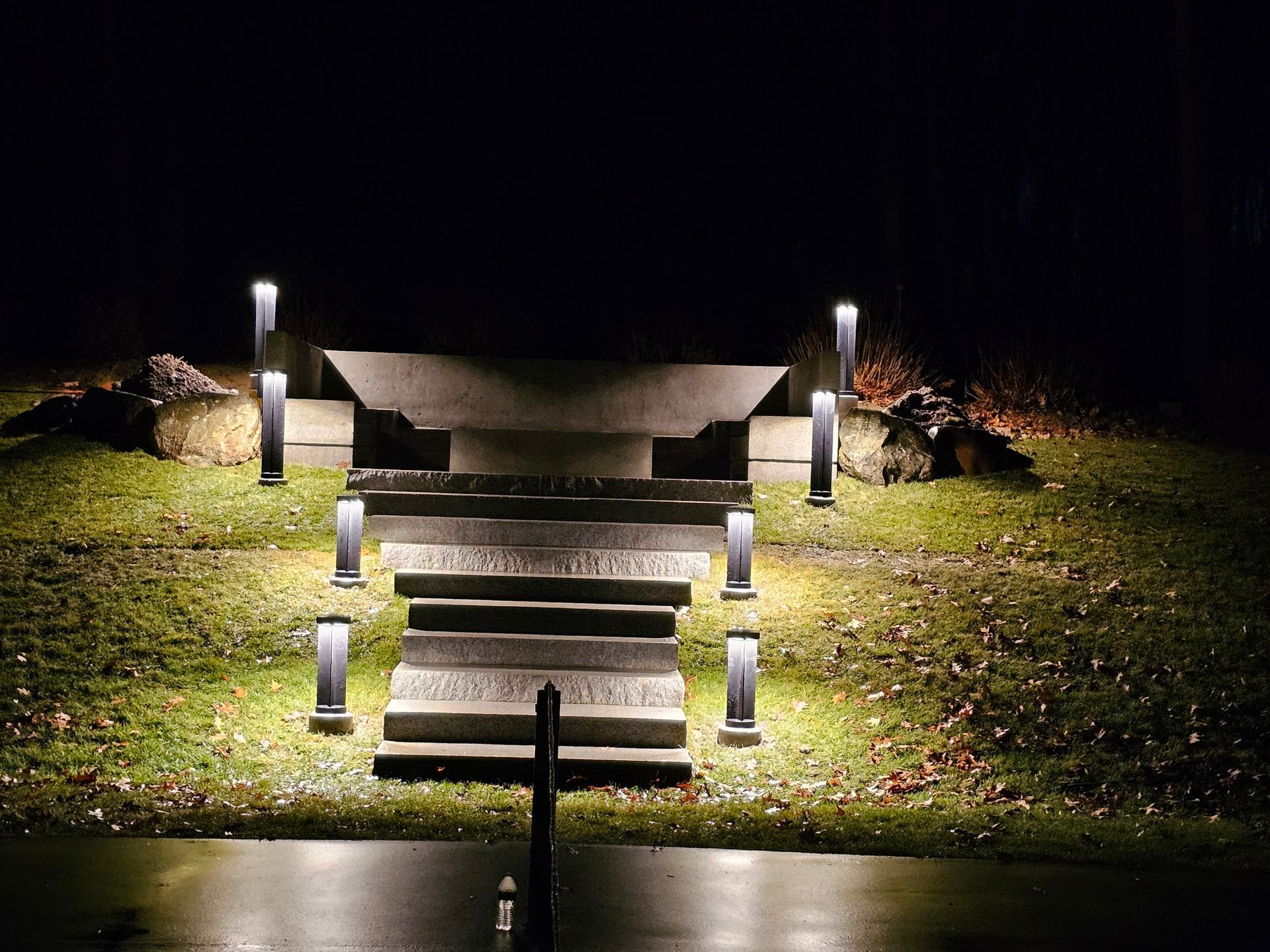 A staircase is lit up at night in a park