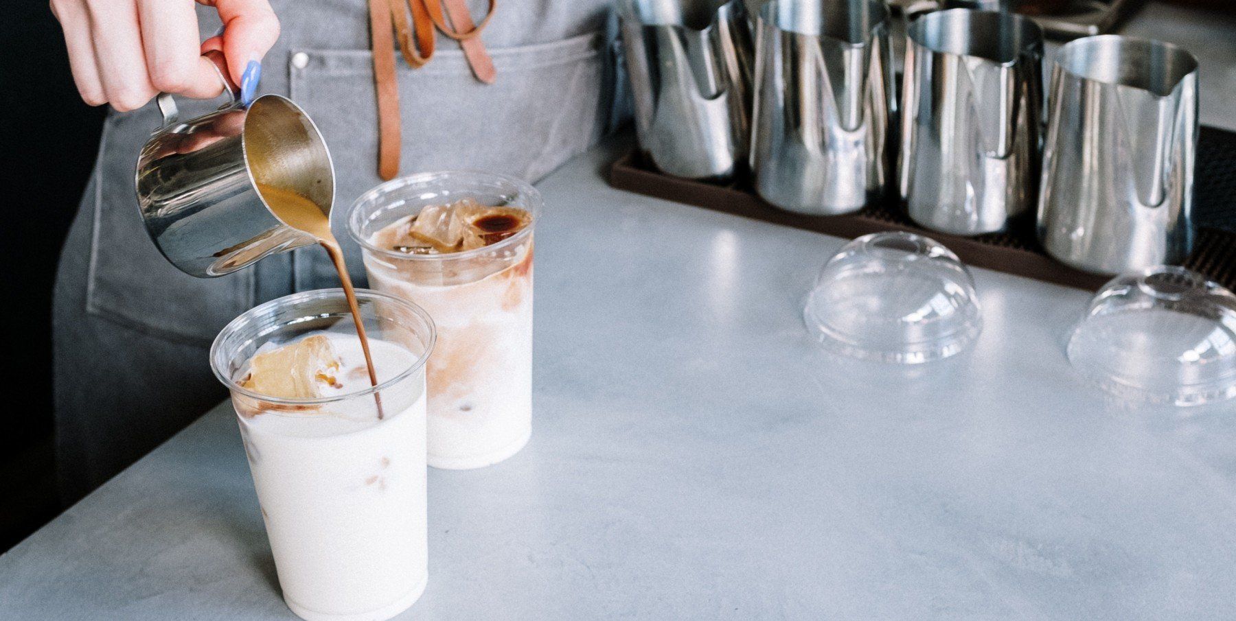 Barista pouring coffee to a cup