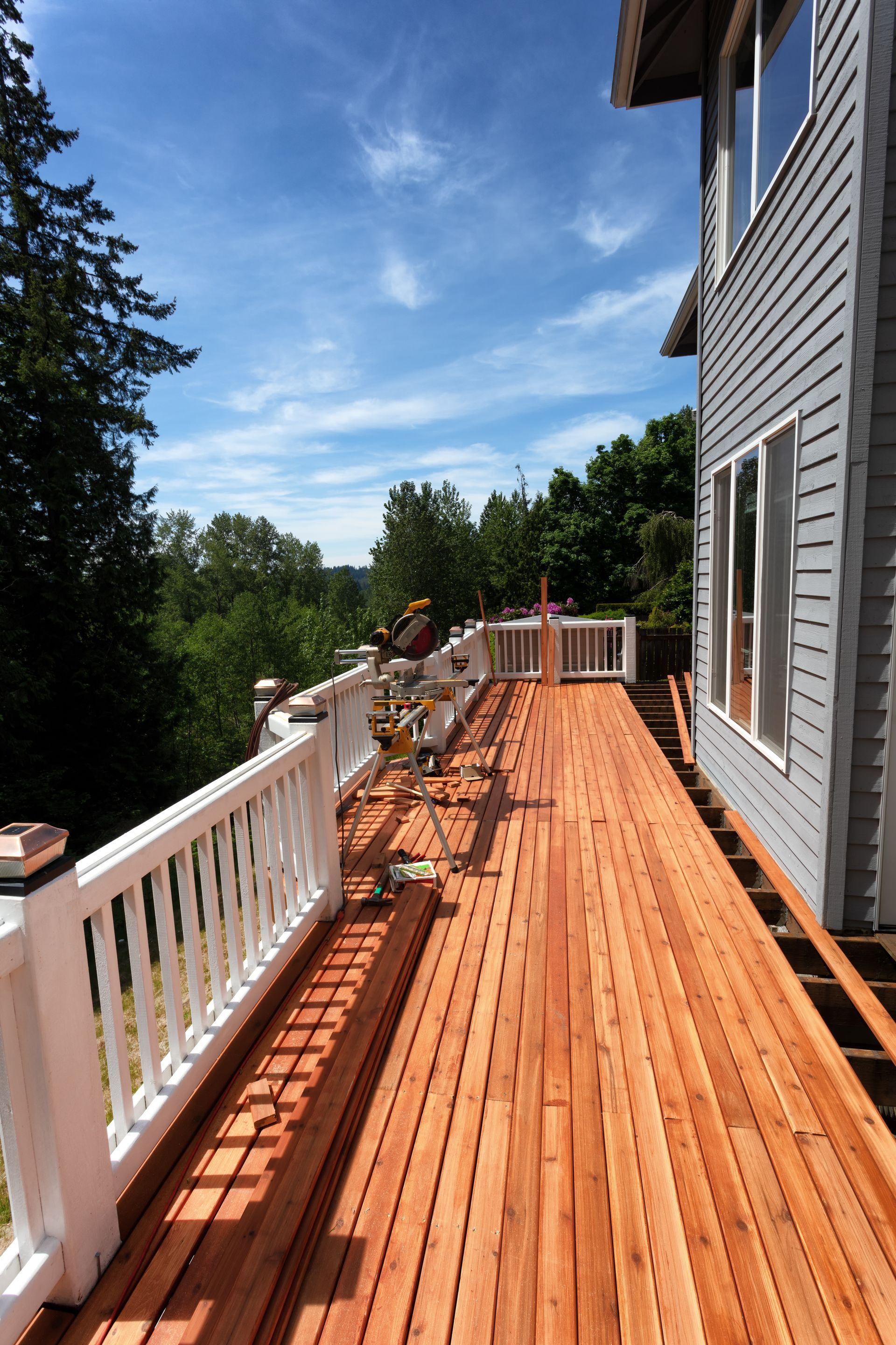 Beautiful stained side deck of a two-story house still being worked on