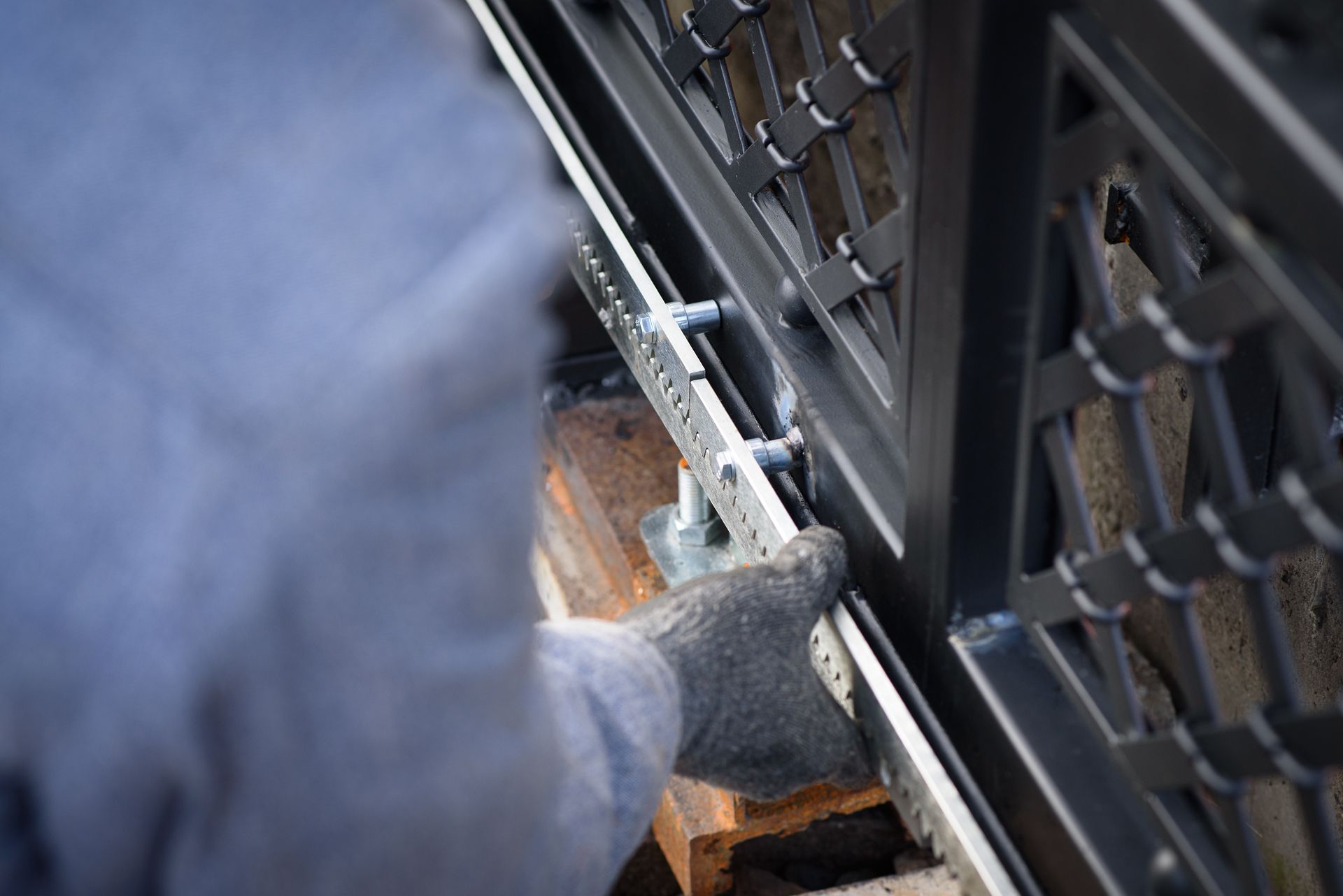 Contractor working on repair of a sturdy chain linked remote fence